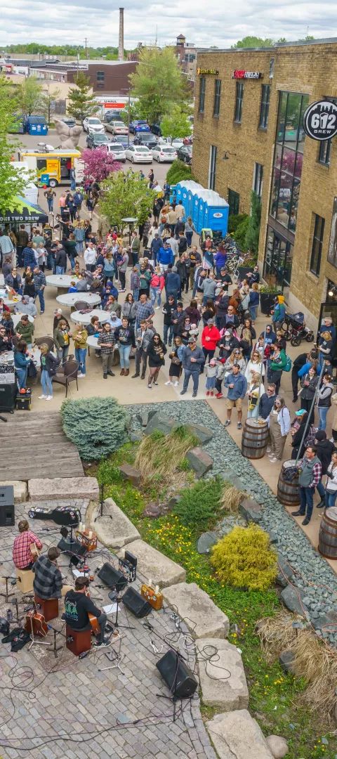 A crowd gathers to view art and listen to live music at the popular summer festival, Art-a-Whirl in Minneapolis