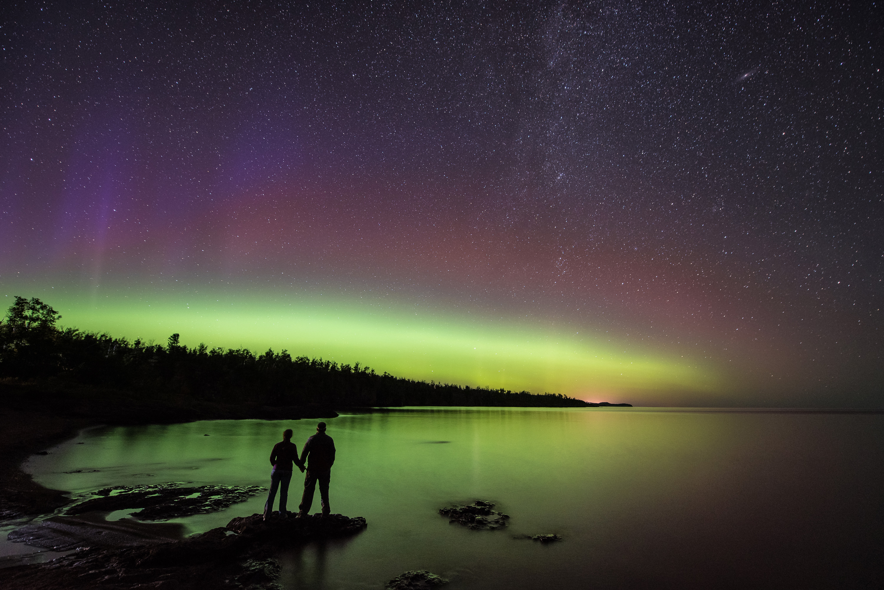 A couple watches the northern lights at Gooseberry Falls State Park
