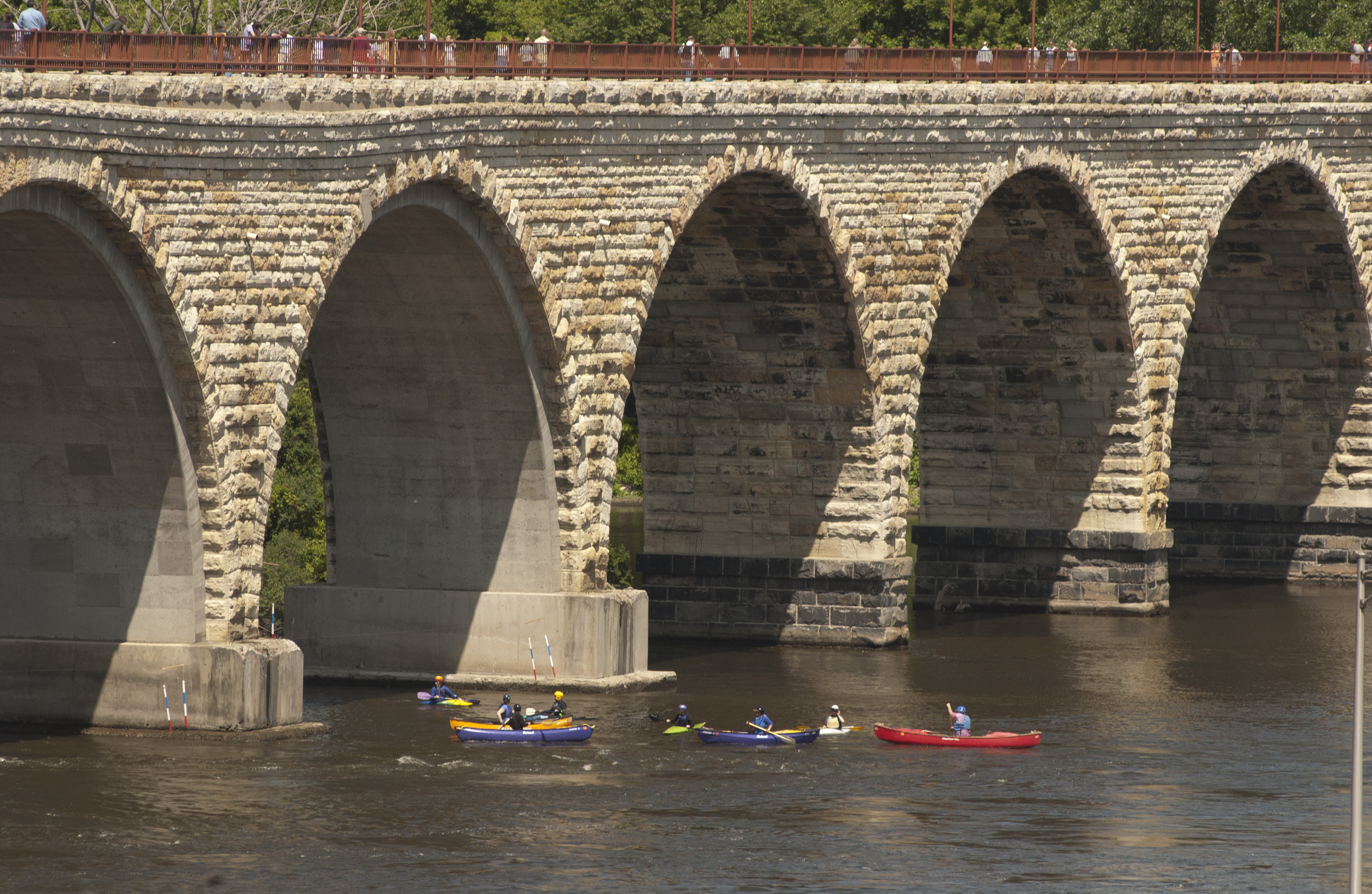 Canoes on the Mississippi River beneath the Stone Arch Bridge