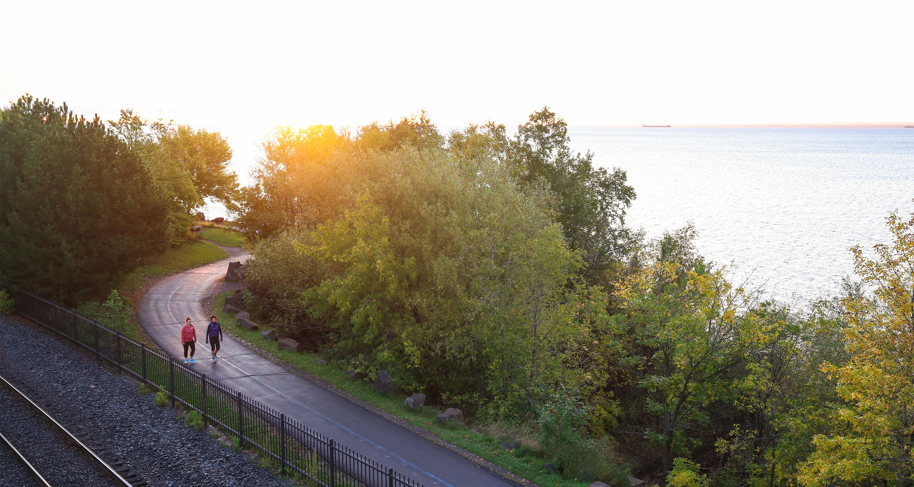 Women walking on Lakewalk sunrise Duluth