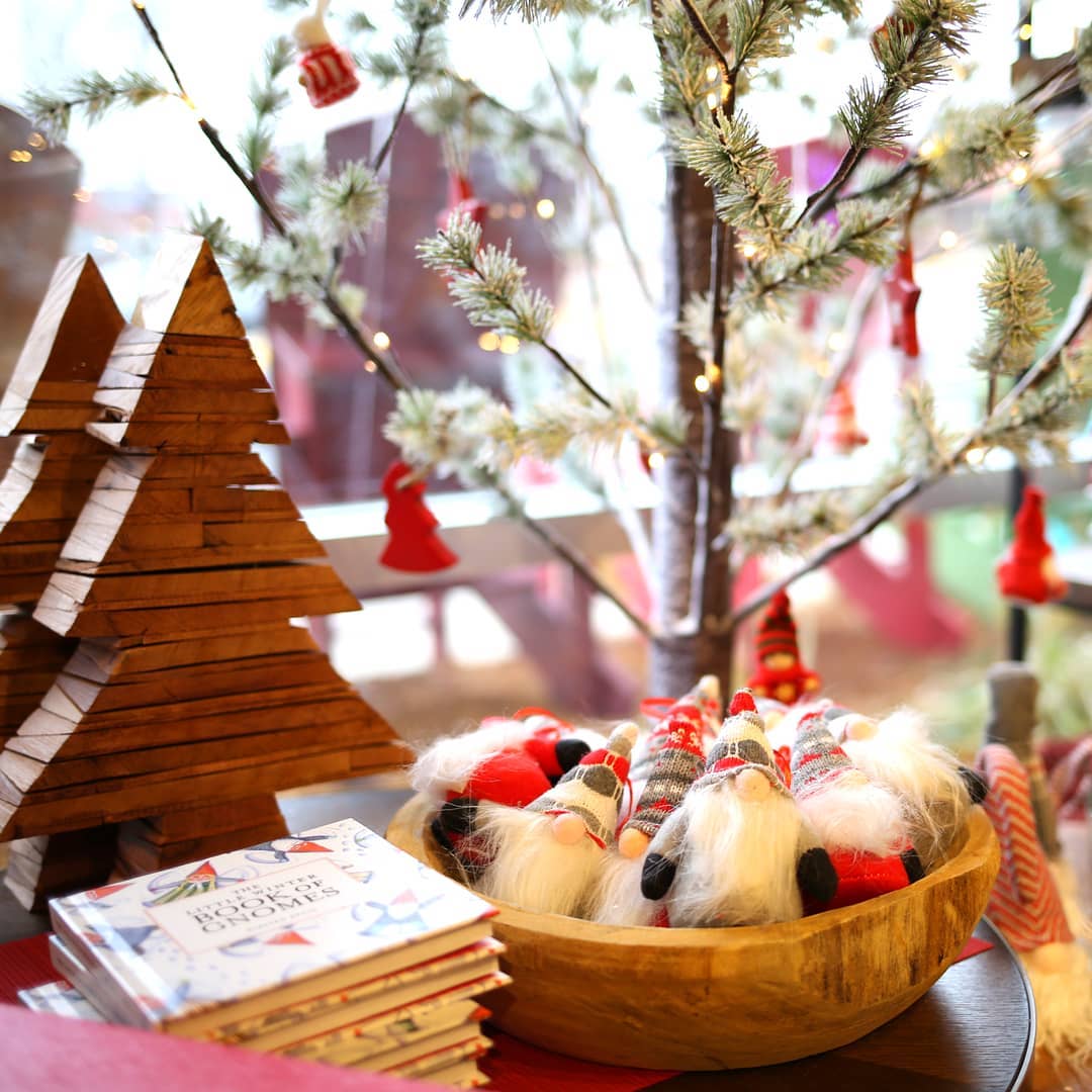 Holiday display with wooden Christmas trees and gnomes