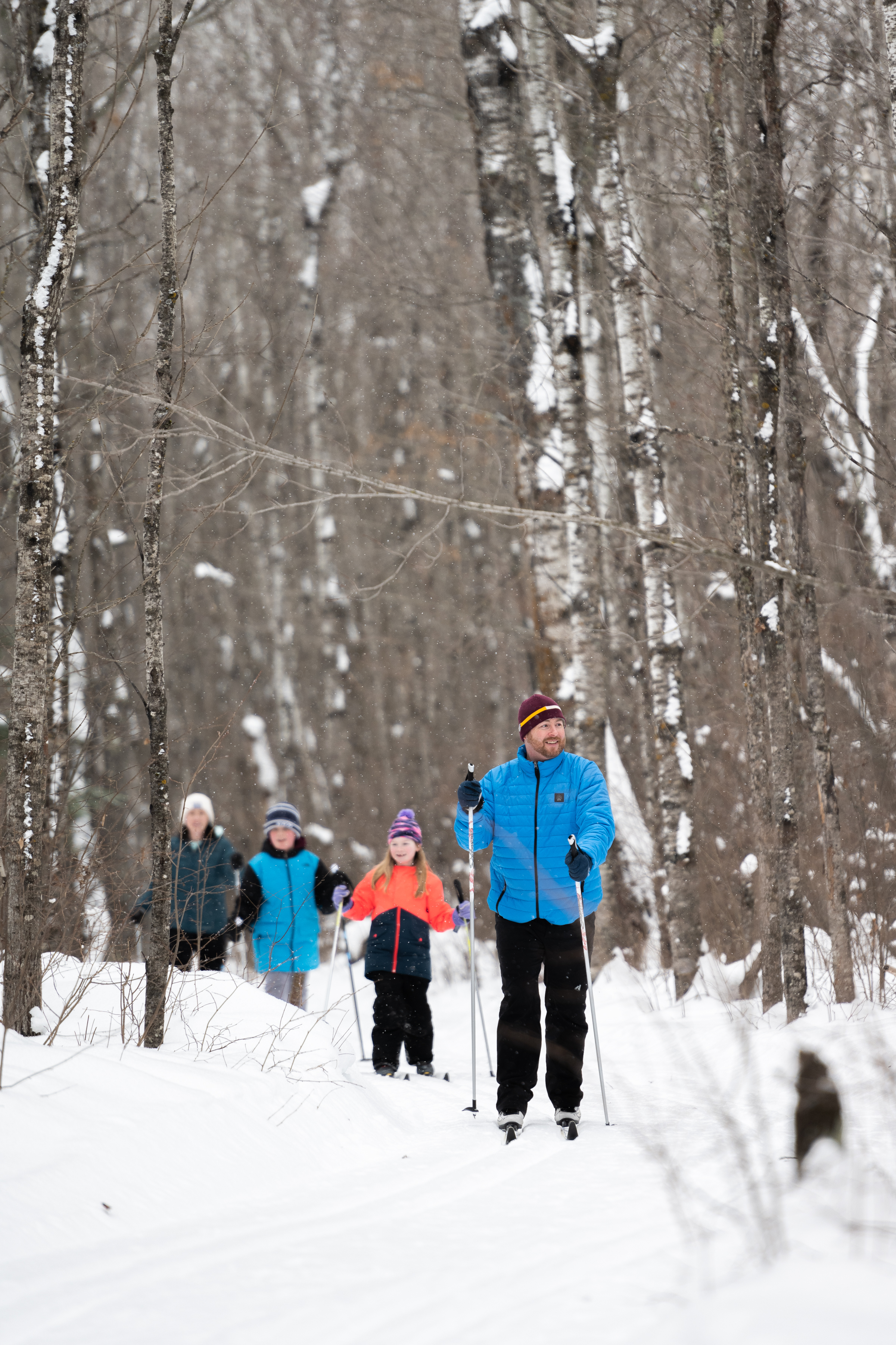 A family cross-country skiing in winter in Northeast Minnesota
