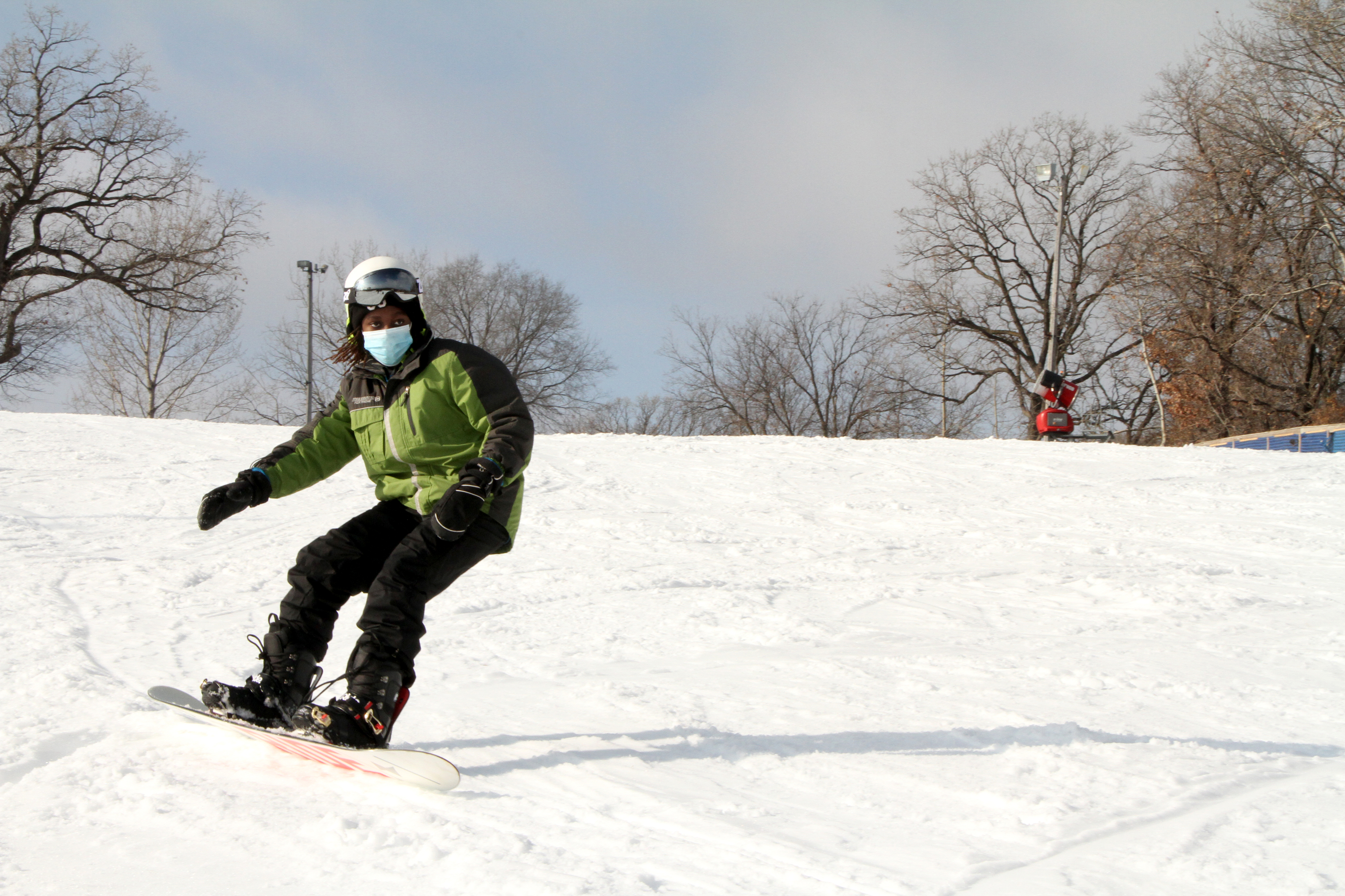Snowboarder wearing a face mask at Buck Hill