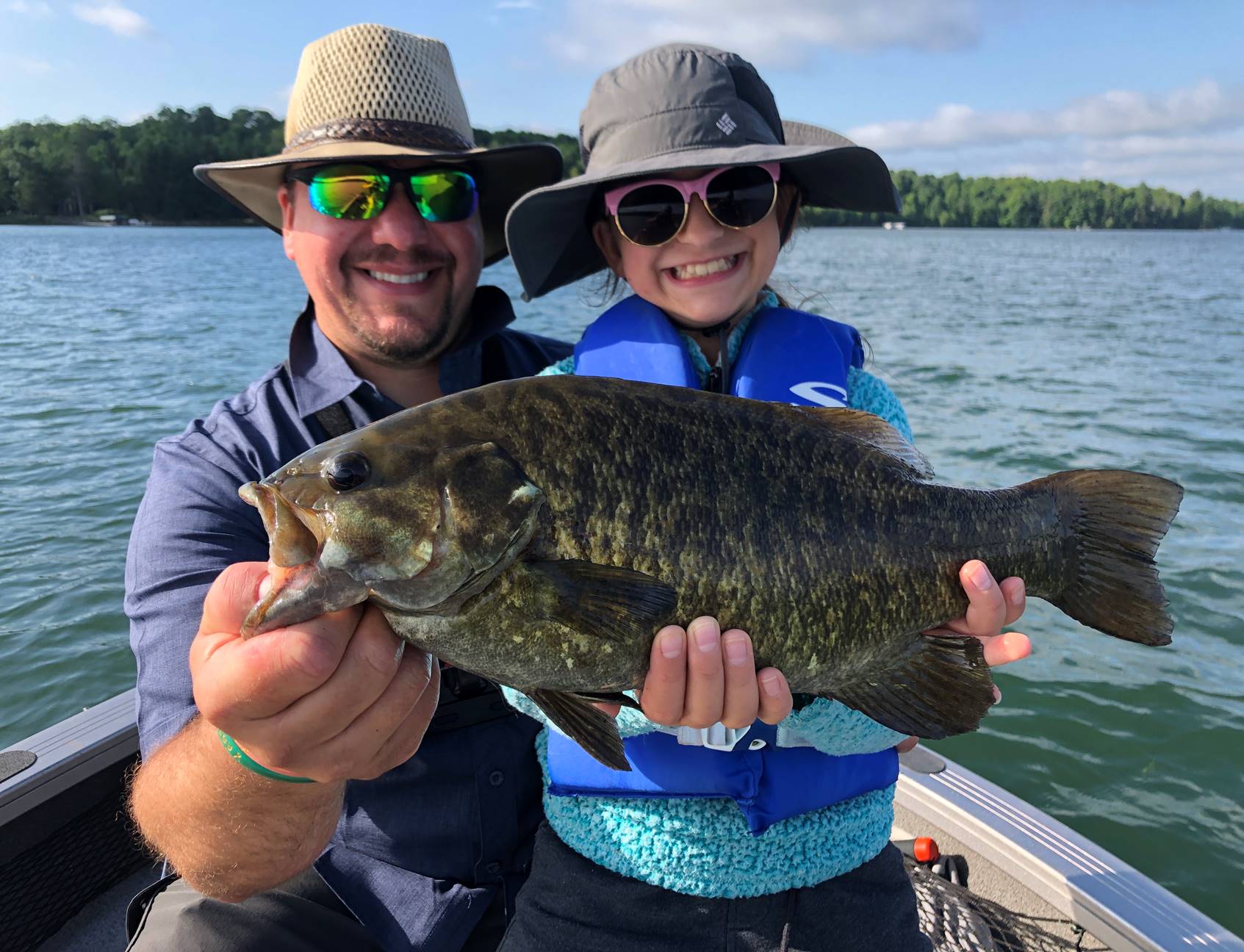 Father and daughter with their smallmouth bass pulled from a Brainerd area lake
