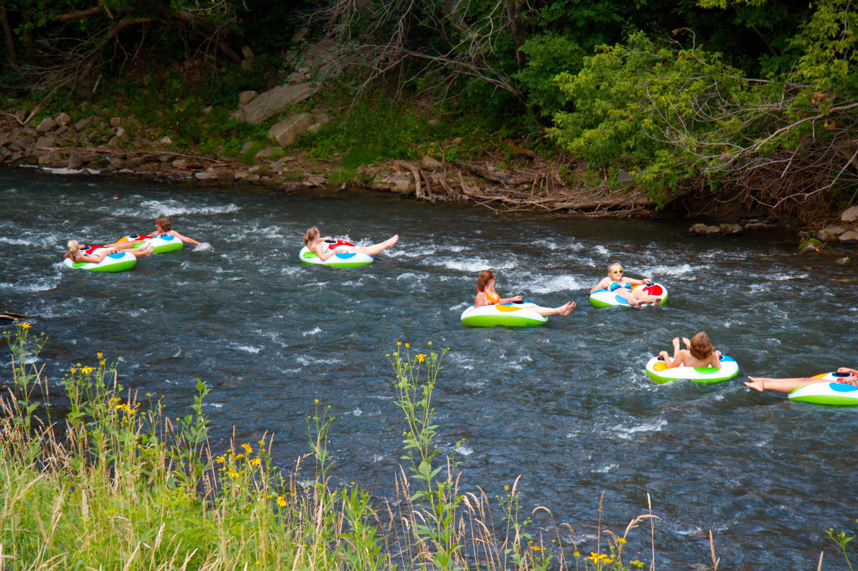 Seven women river tubing on the Root River in southern Minnesota