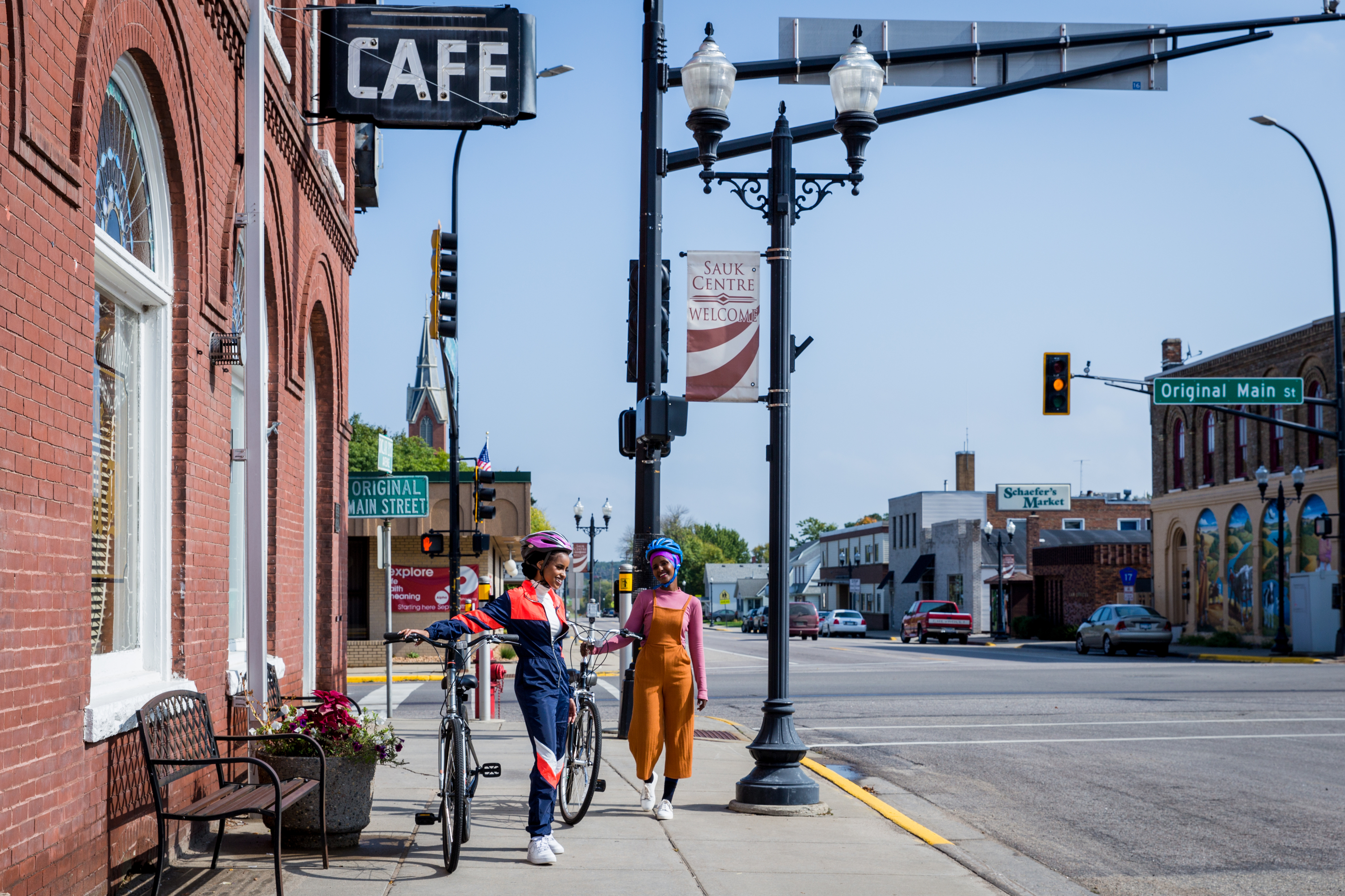 Two women biking on Main Street, Sauk Centre