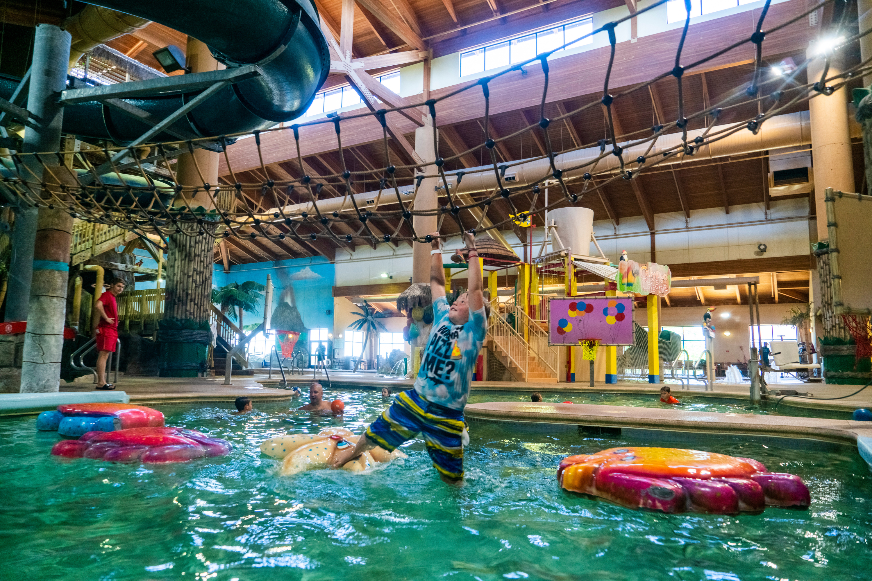 Climbing a rope bridge in Arrowwood Resort, Alexandria