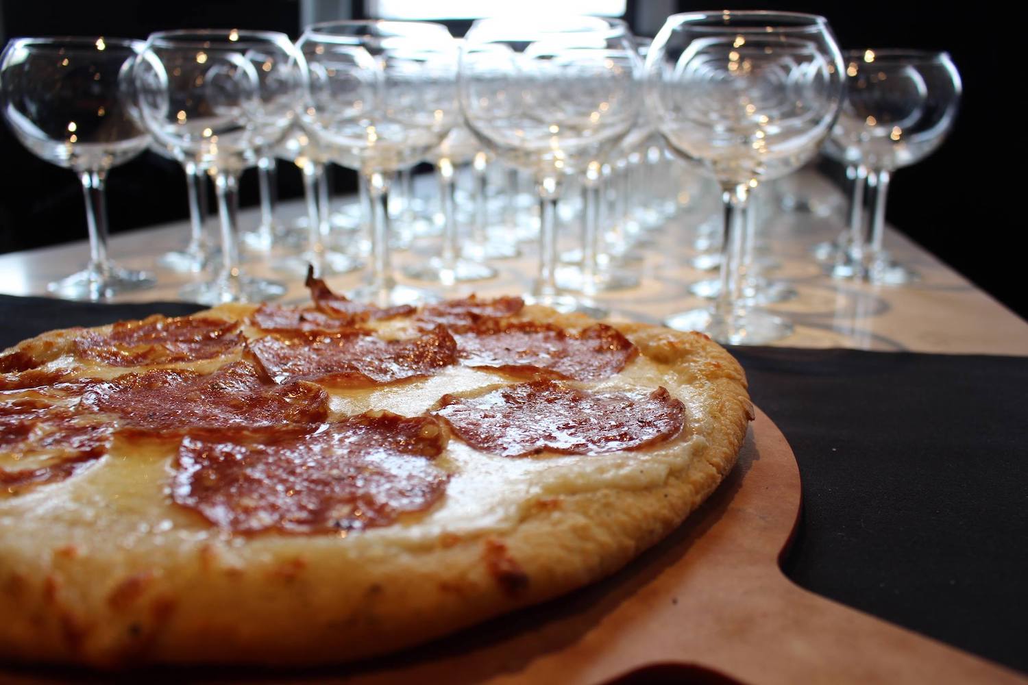 A pepperoni pizza and wine glasses at Mucci's Italian