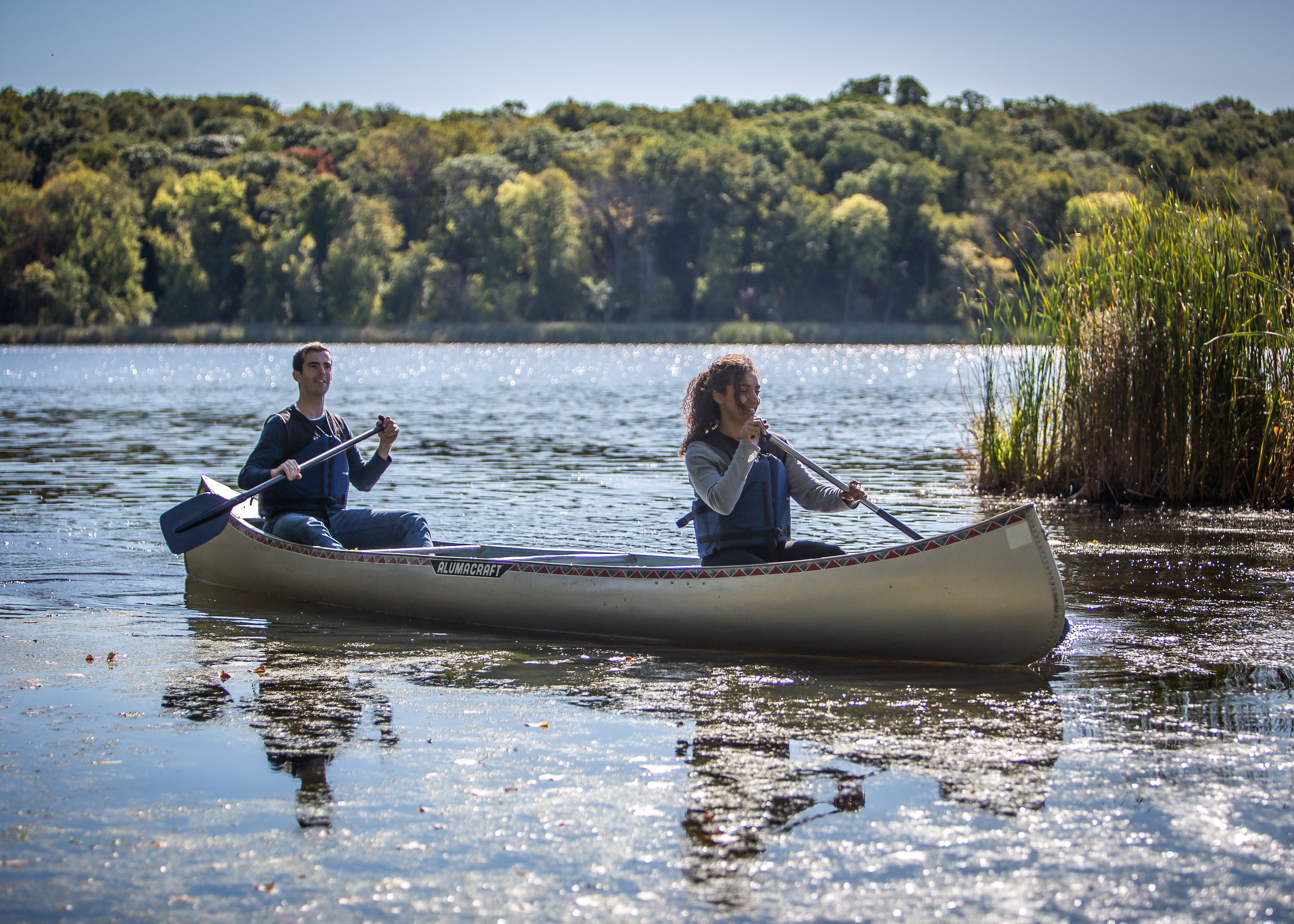 A couple people canoe at Westwood Hills Nature Center