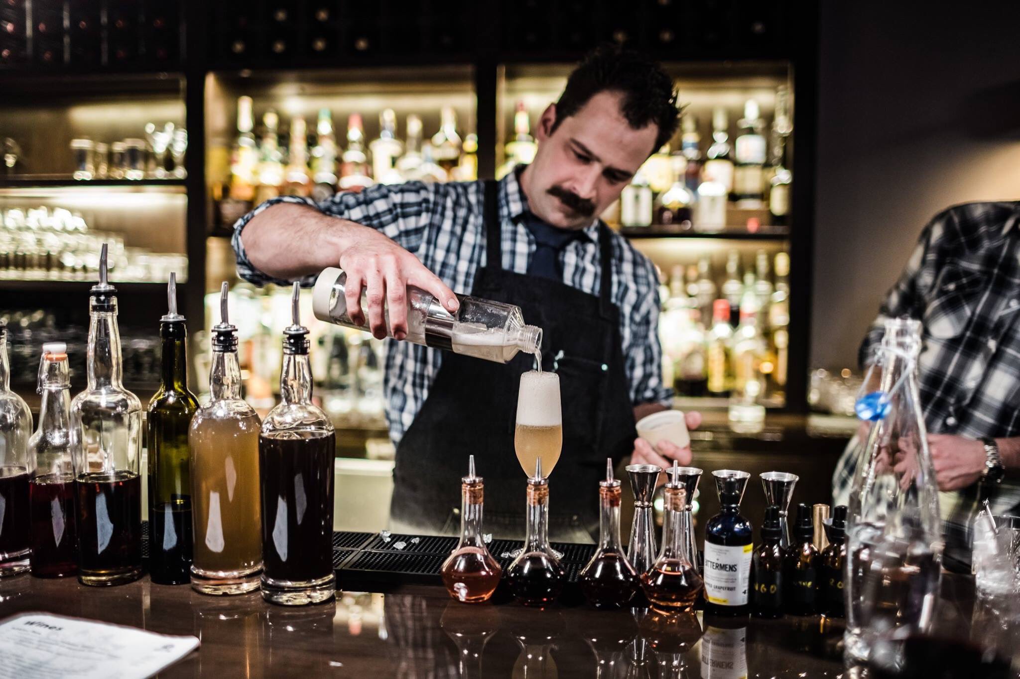 A bartender prepares a cocktail at Bitter and Pour in Rochester