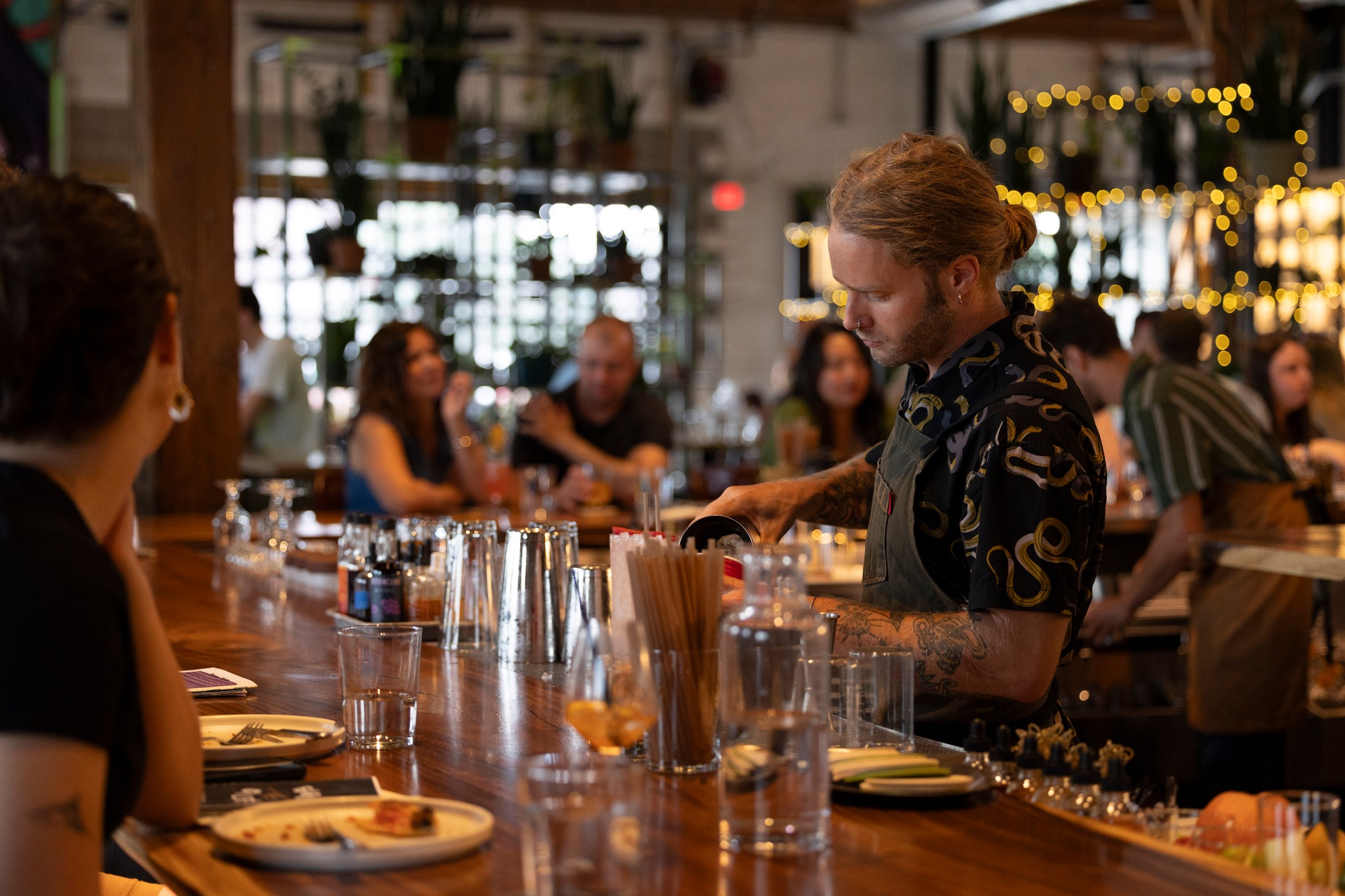 A bartender pours a cocktail at Earl Giles Distillery
