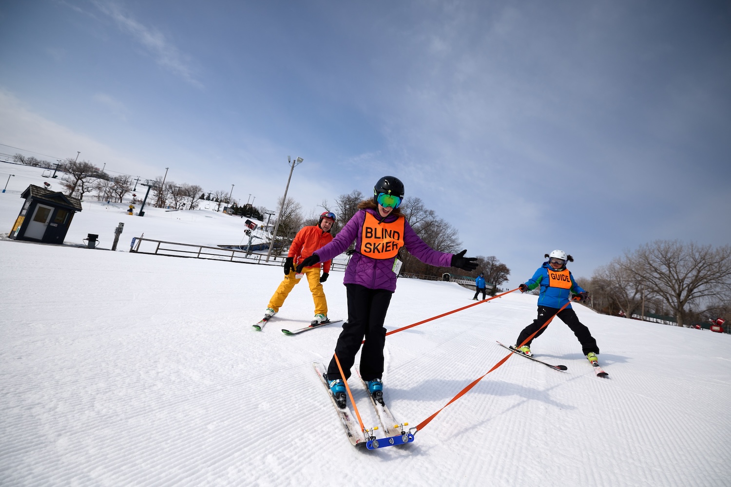 A blind skier takes a guided ride down Buck Hill in Burnsville