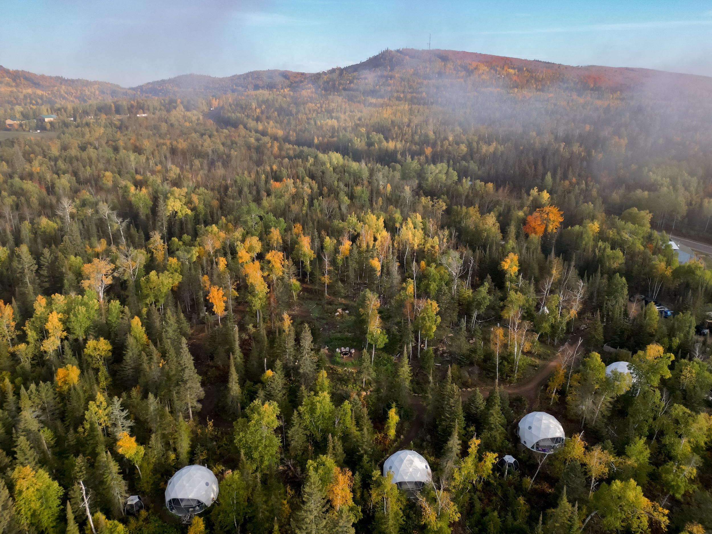 A drone shot of Klarhet's four geodesic domes in Lutsen