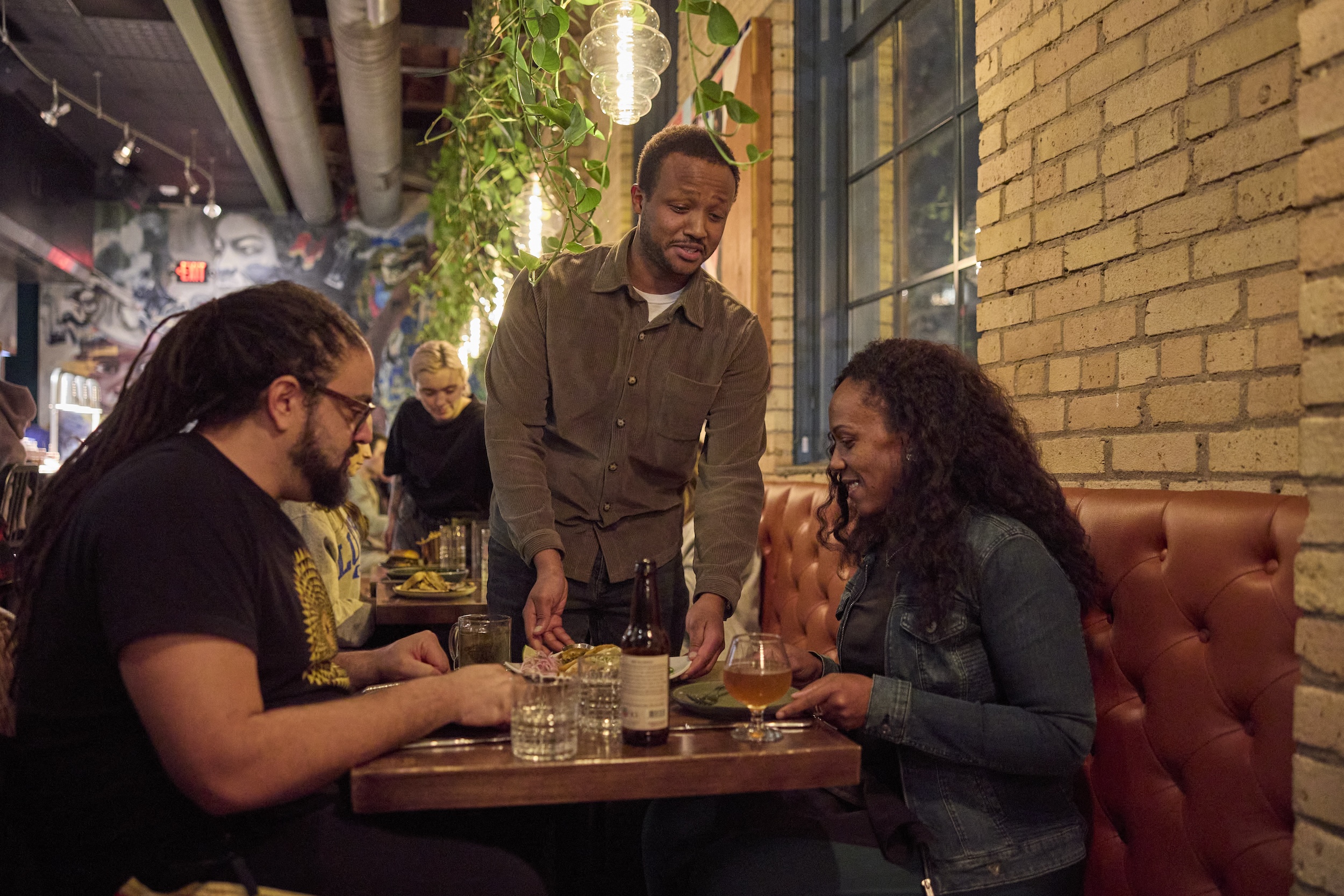 StepChld owner Kamal Mohamed greets a couple diners