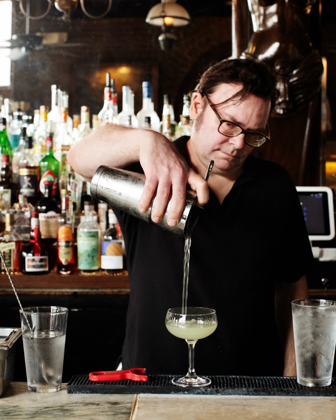 A bartender pours a cocktail at WA Frost & Company