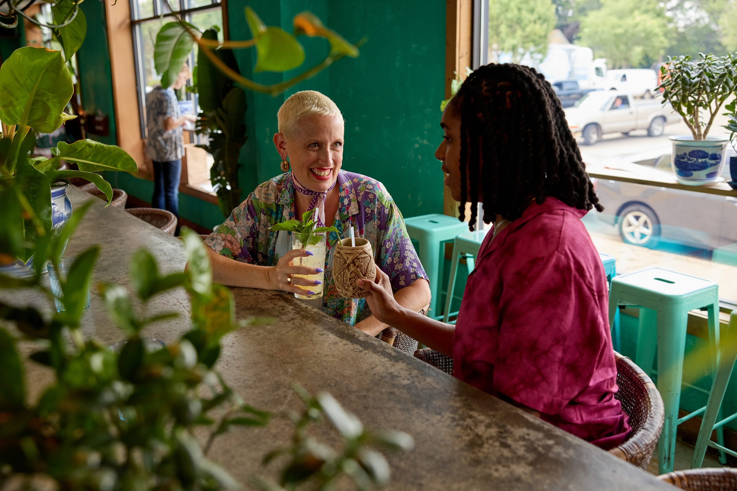 A couple toasts their tropical cocktails at Hai Hai