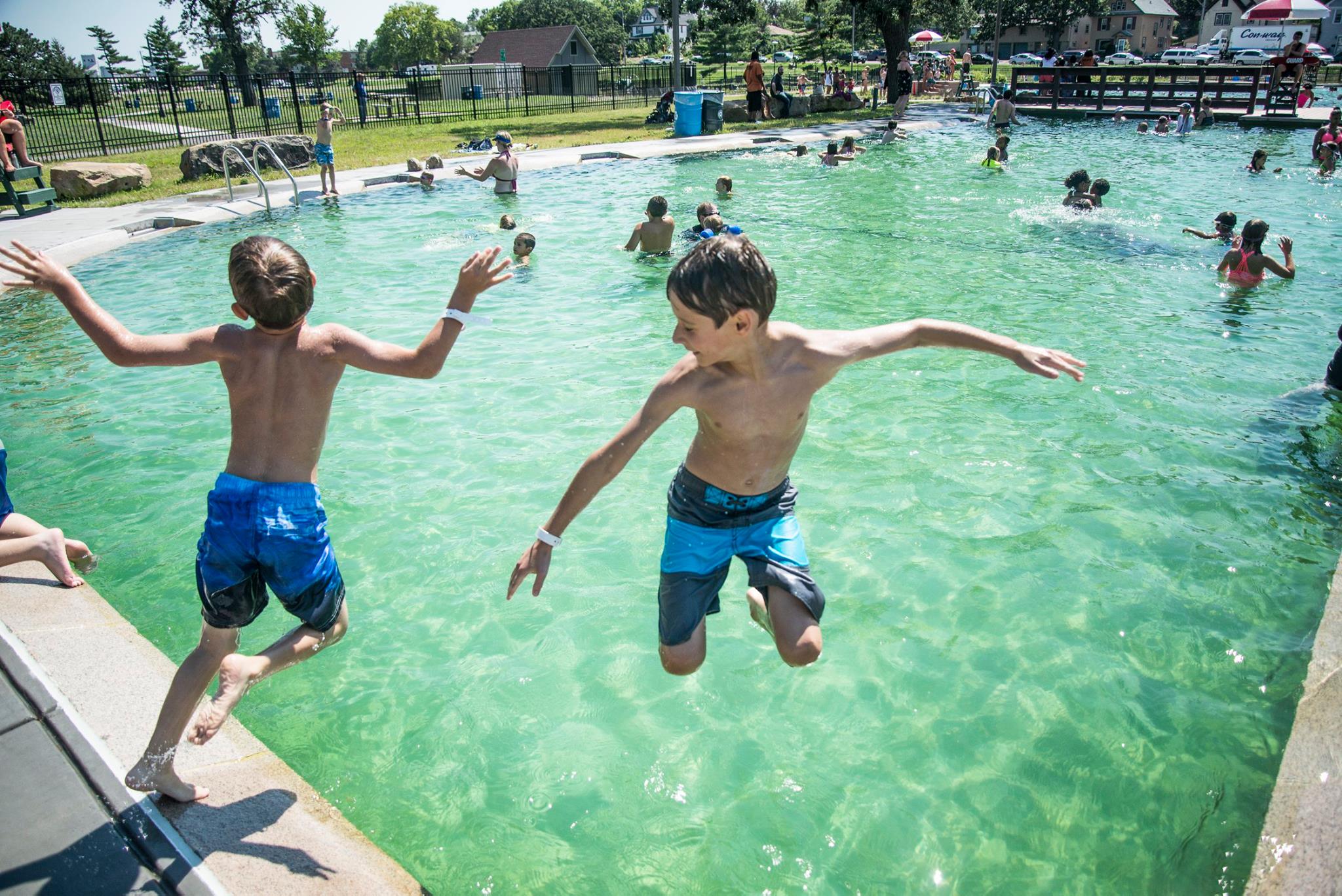 Kids jumping into Webber Natural Swimming Pool