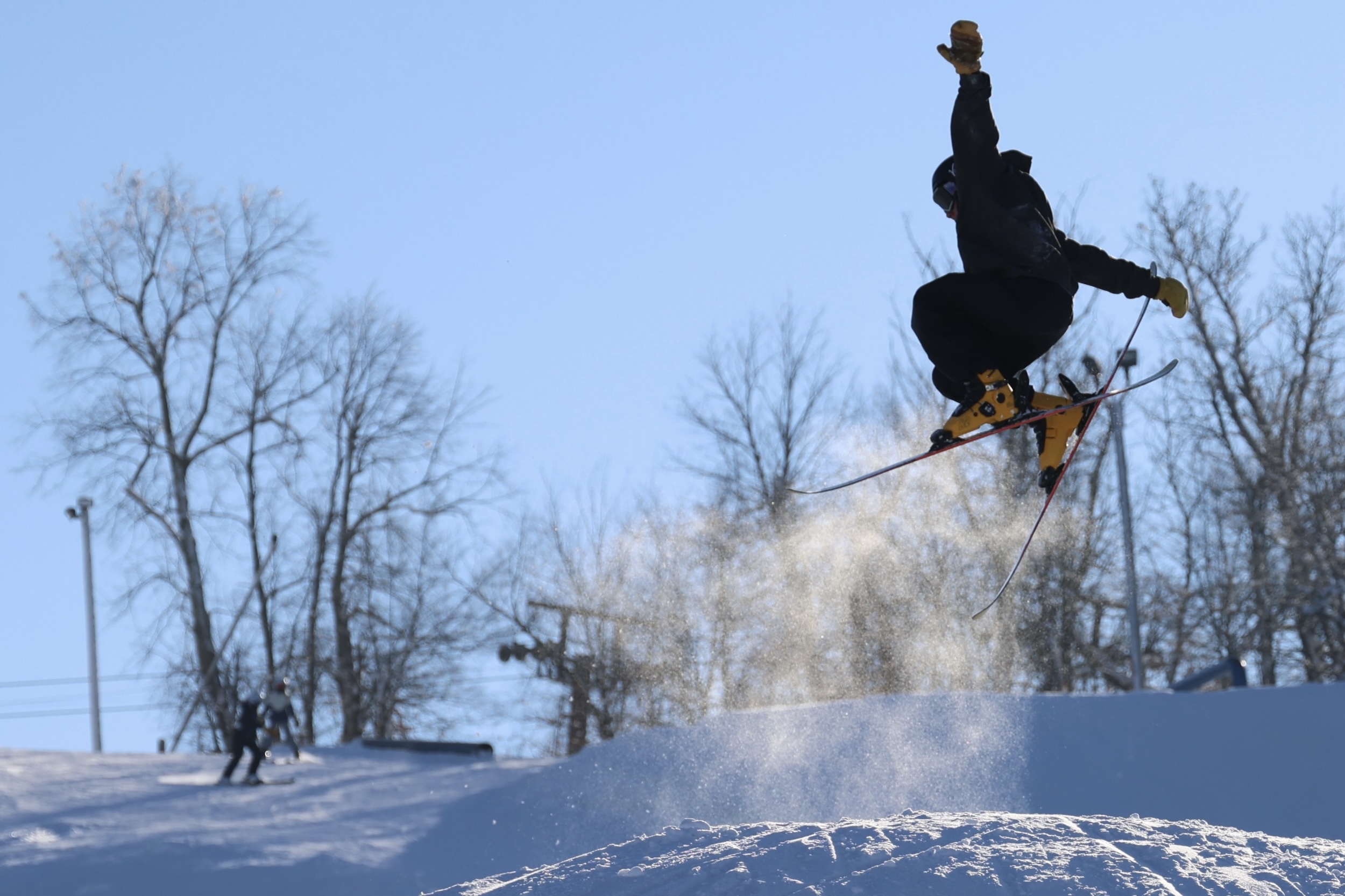 A snowboarder uses a ski jump at Andes Tower Hills