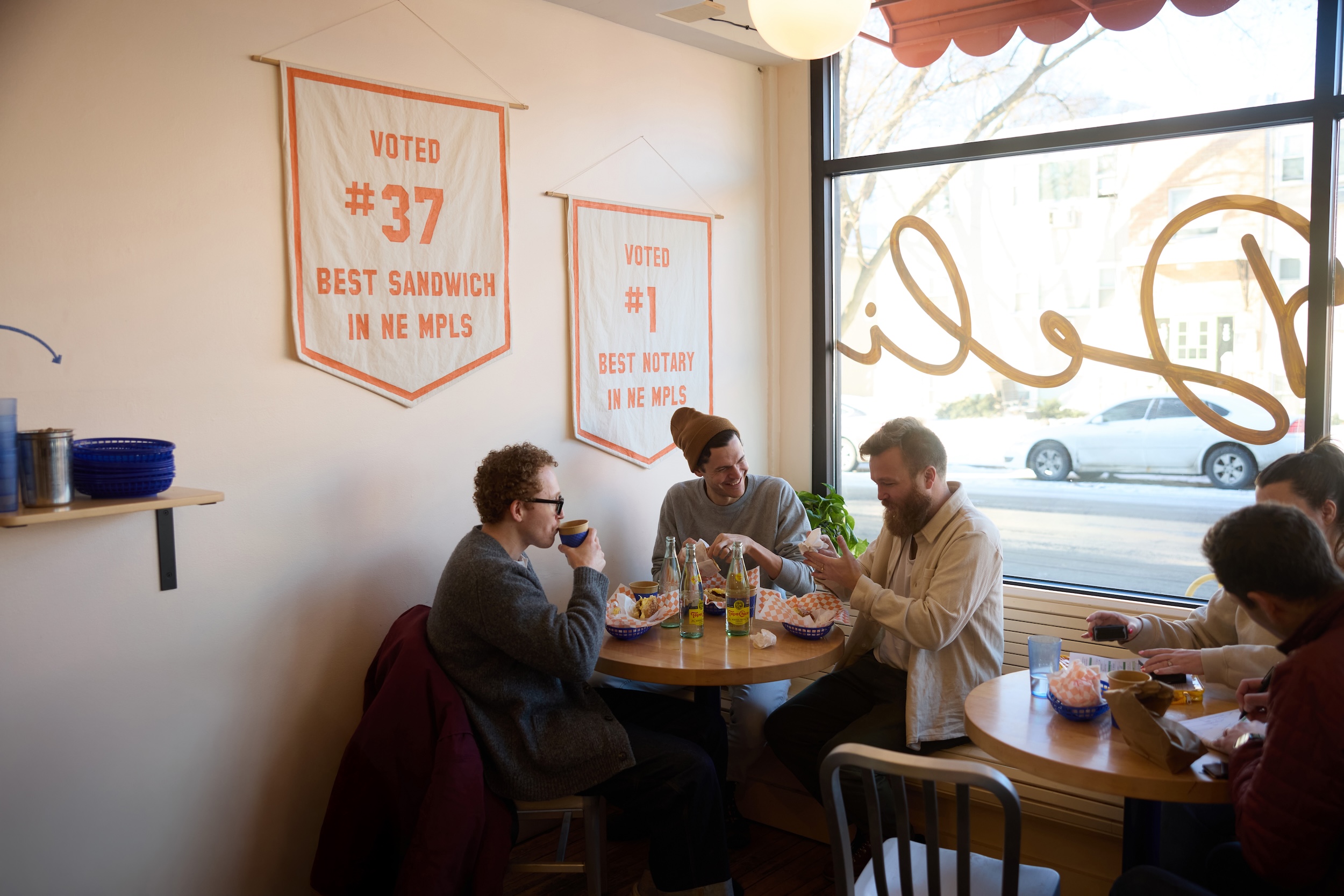 A group of friends eat breakfast sandwiches at Marty's Deli
