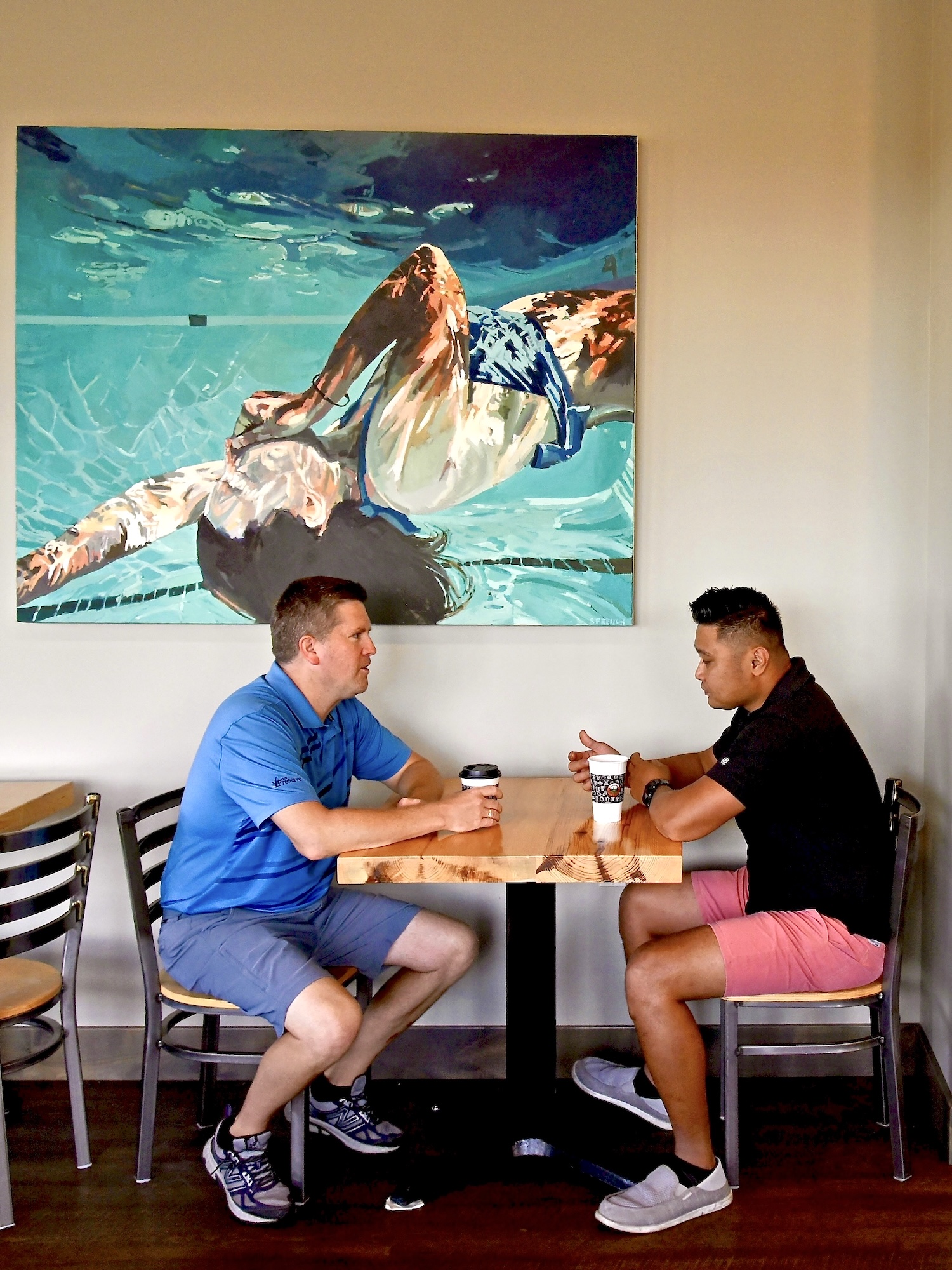 A couple friends drink coffee at Stonehouse Coffee's Nisswa location