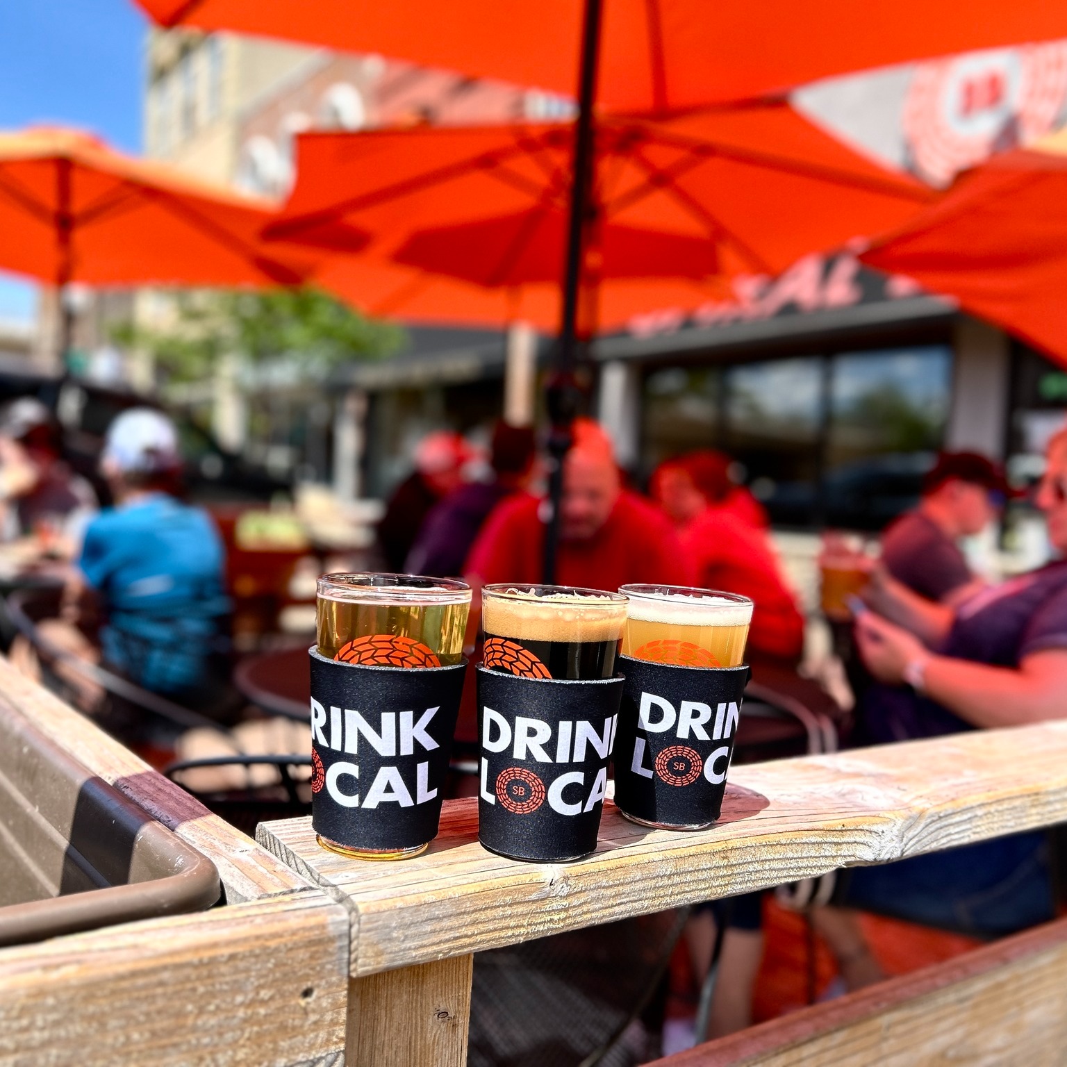 A trio of pints on a patio at Spiral Brewery