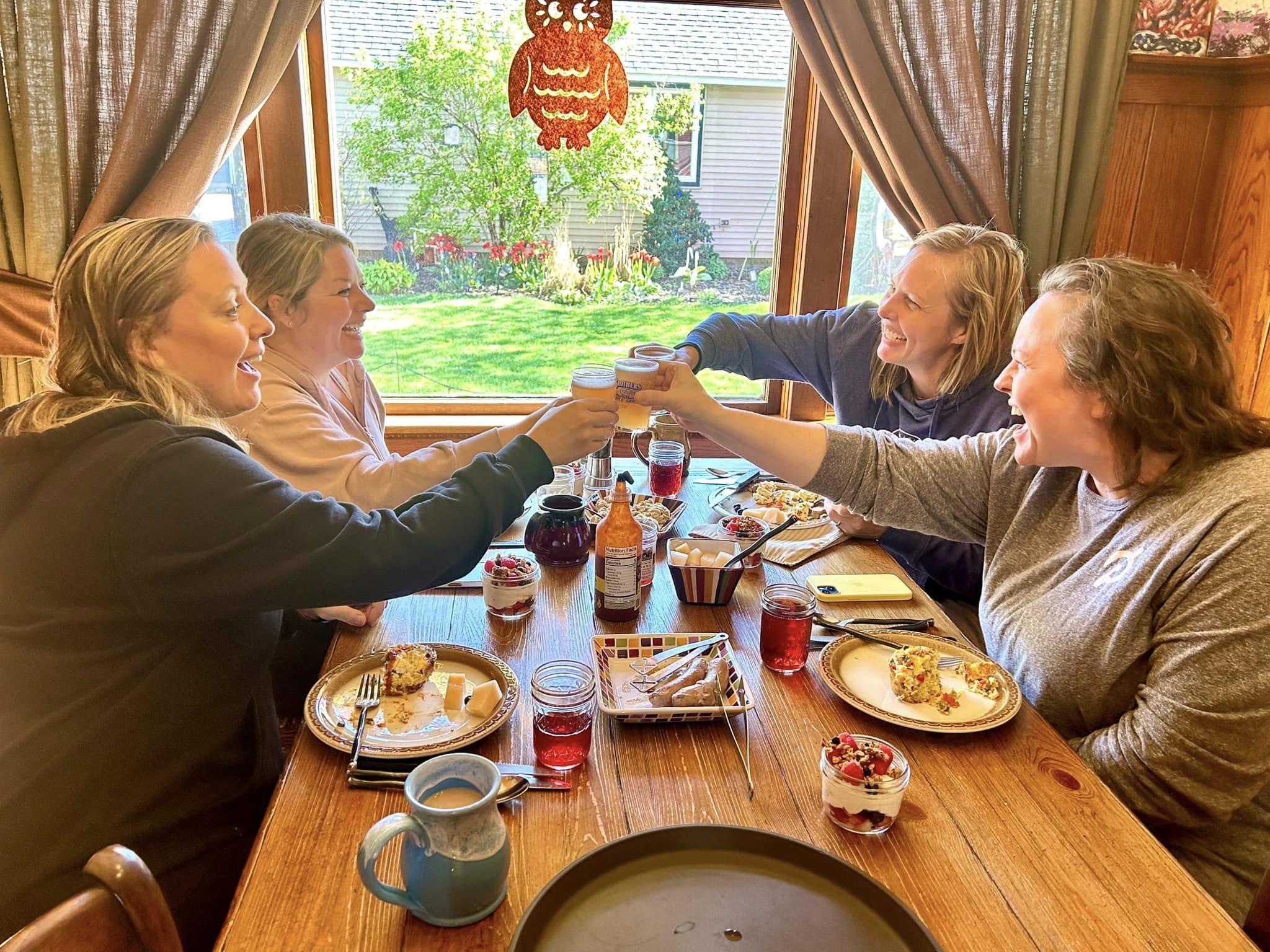 A group of friends toast one another at Turning Waters B&amp;B