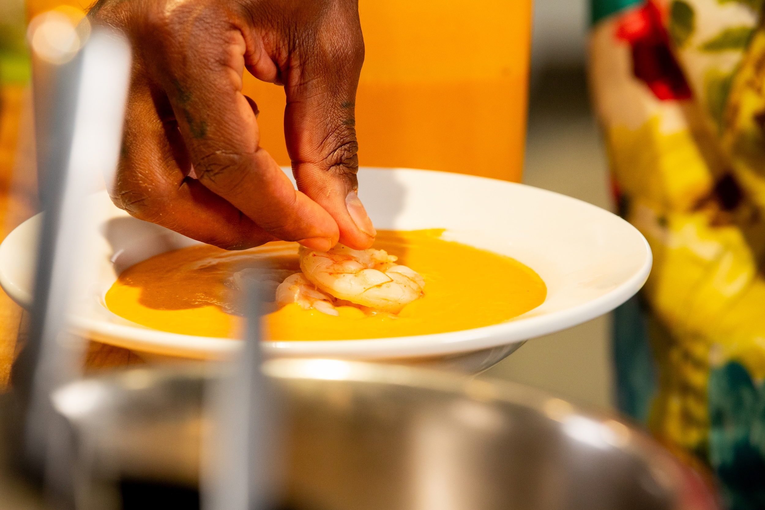 Chef Matteo Mackbee makes his shrimp bisque dish at Krewe