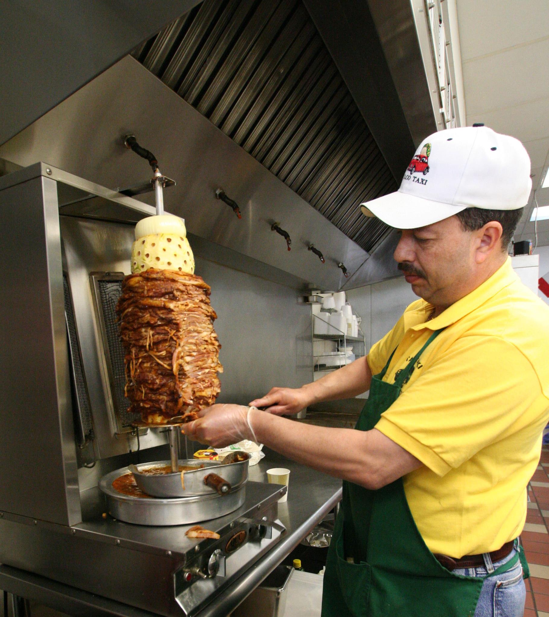 Taco Taxi shaves fresh al pastor meat off its trompo