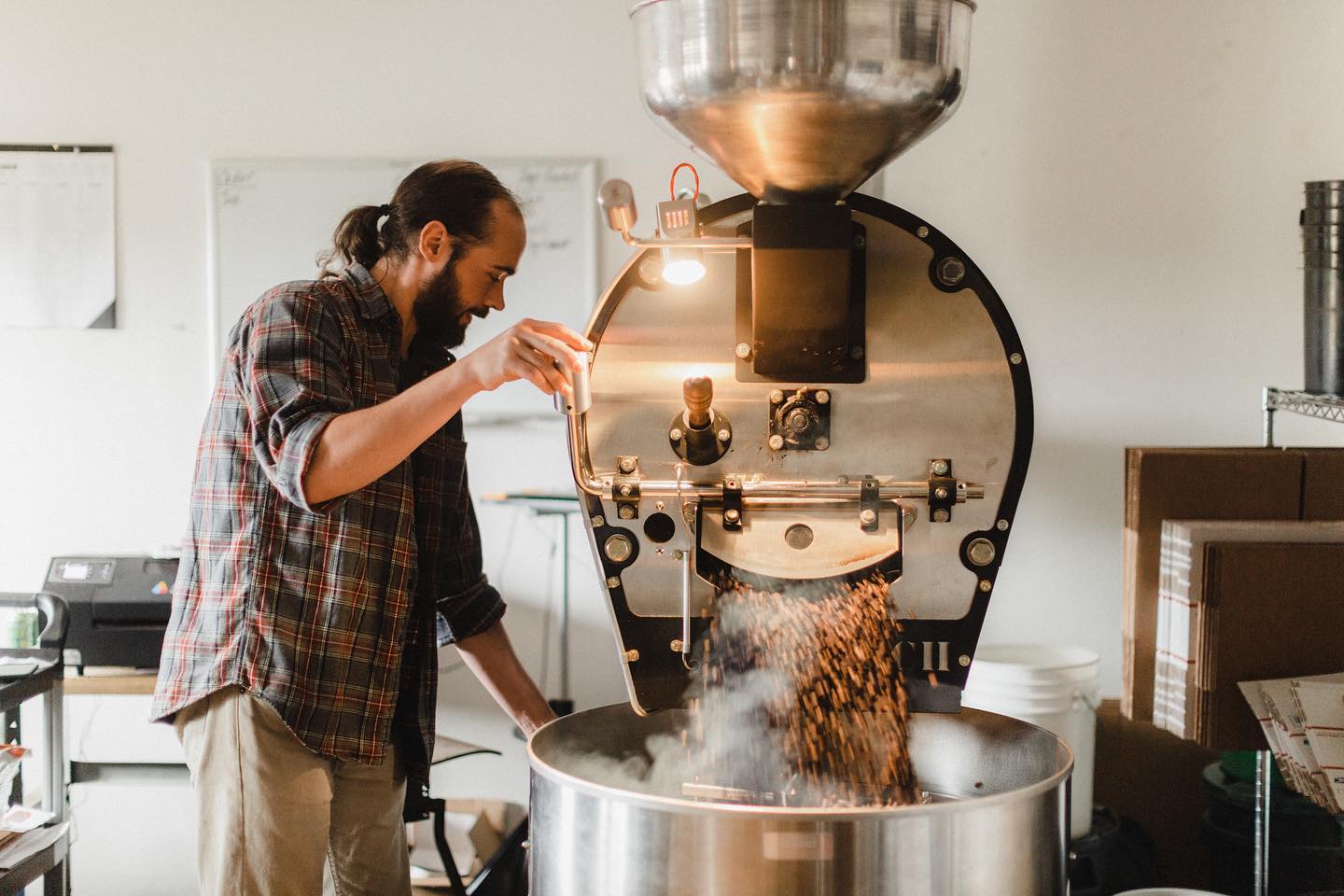 An employee roasts beans at Fika Coffee