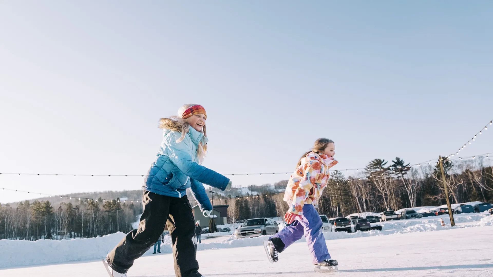 Two children ice skate at Spirit Mountain in Duluth