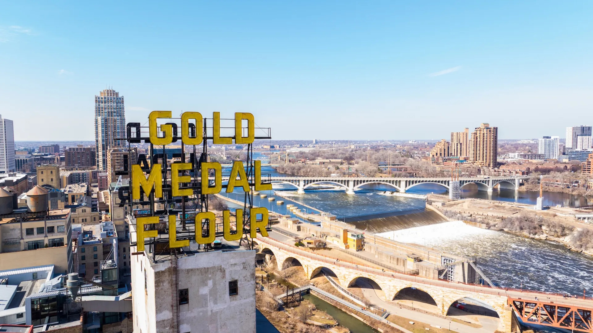 A drone shot of the Stone Arch Bridge and downtown Minneapolis