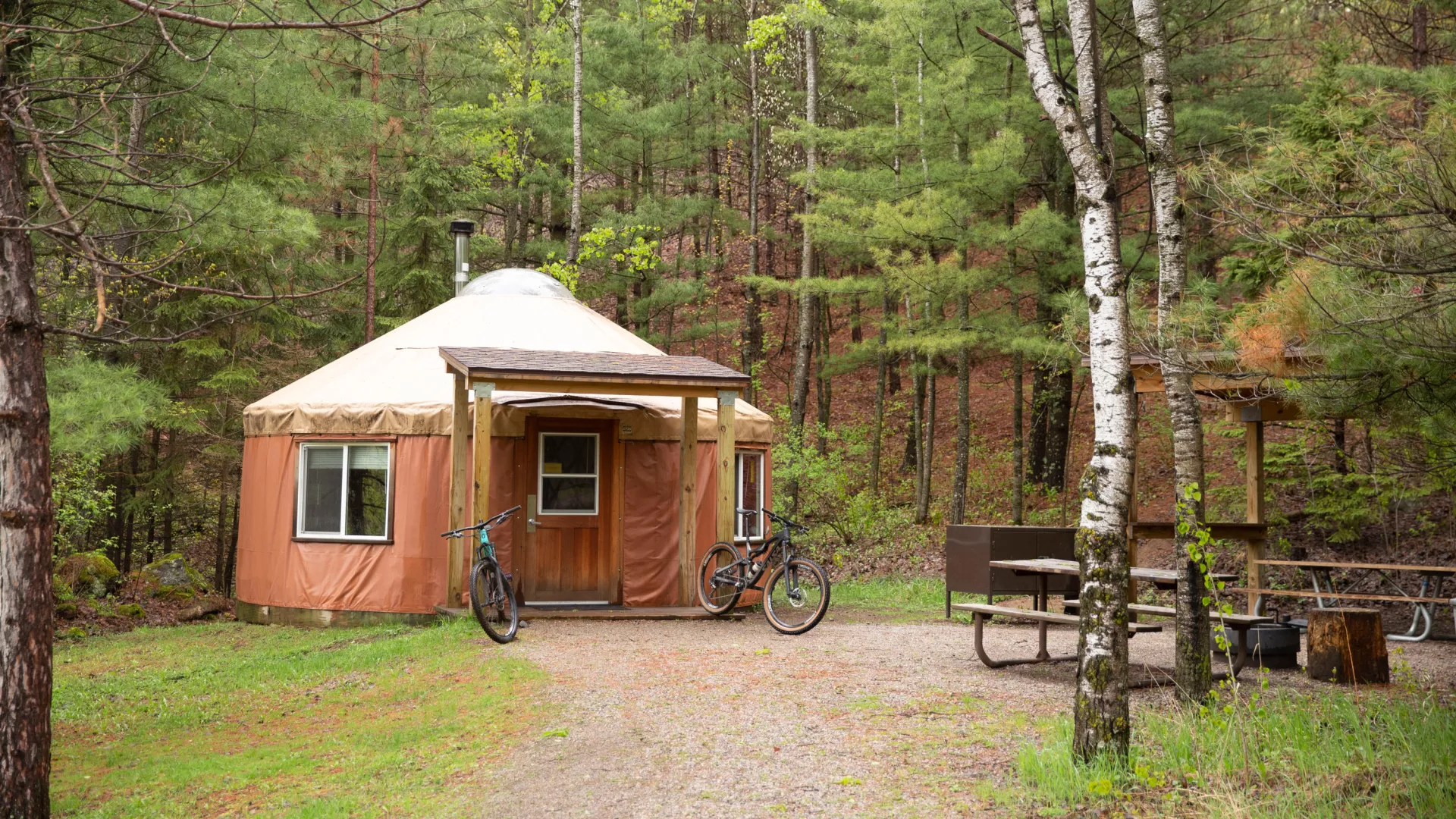 Two mountain bikes parked outside of a yurt in Cuyuna