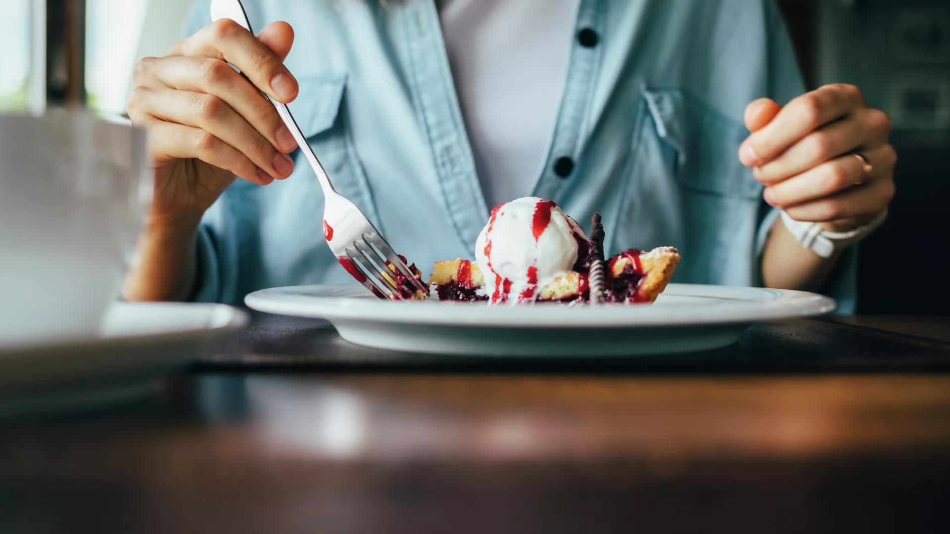 Woman eating pie with ice cream