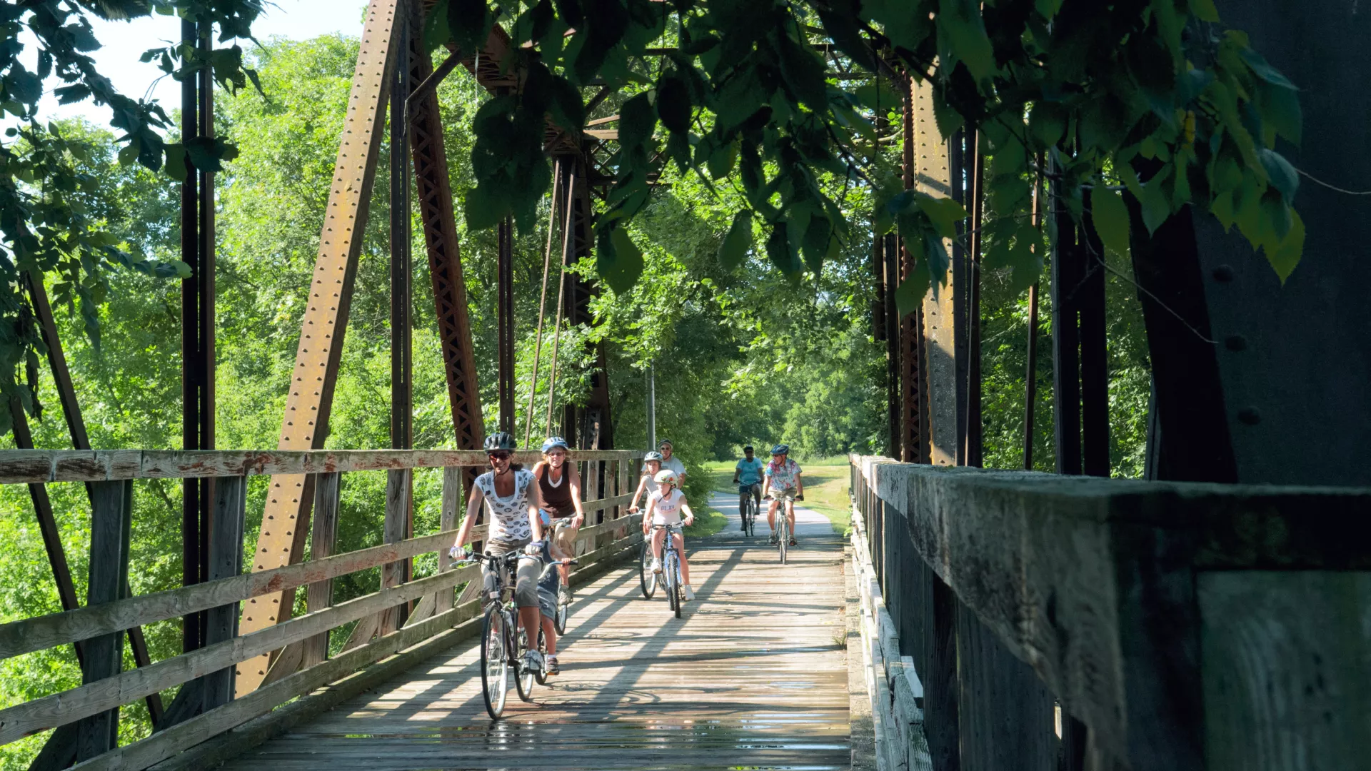 Biking over a bridge on the Root River Trail