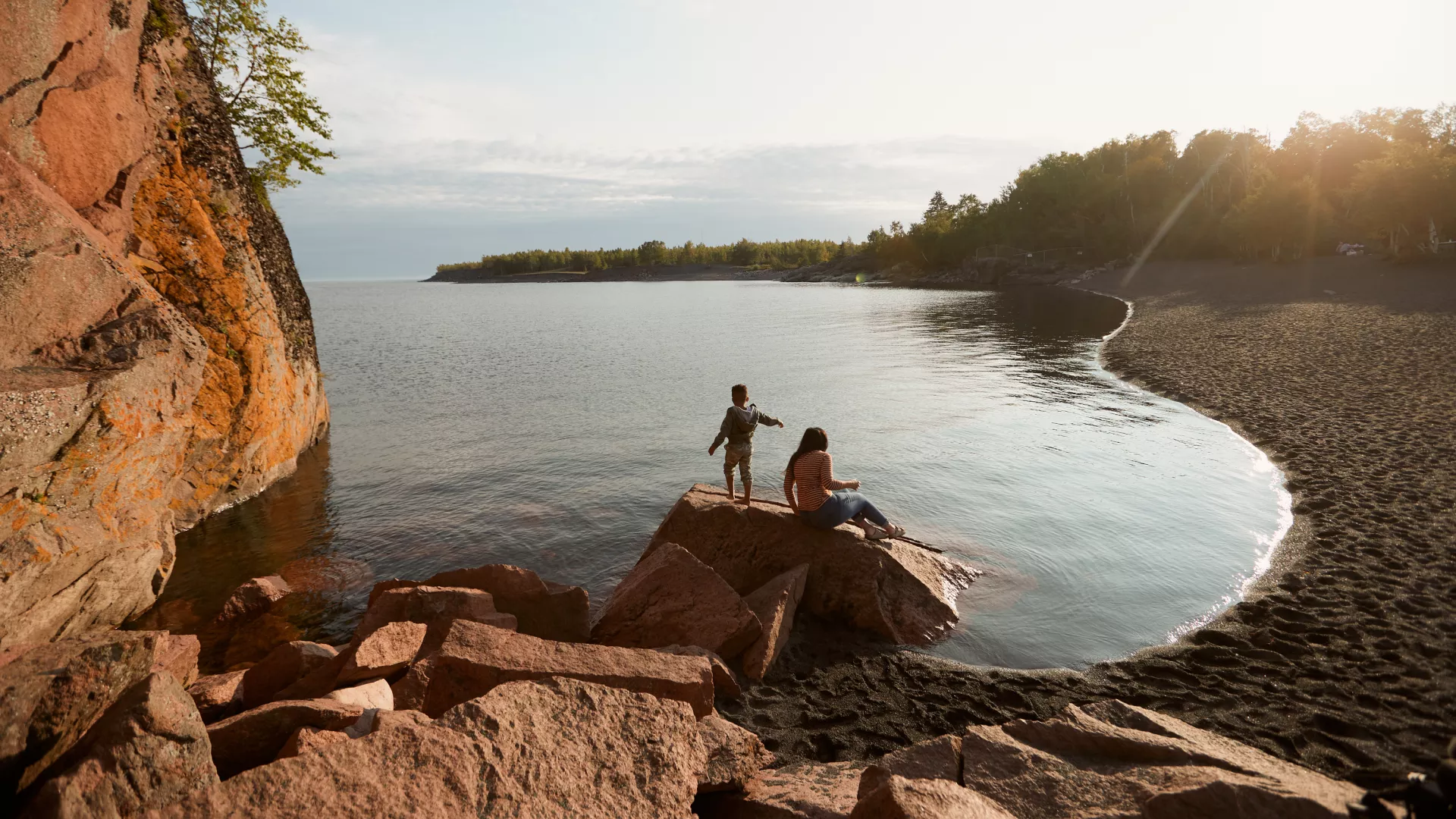 Mother and son play together by the shore of Lake Superior