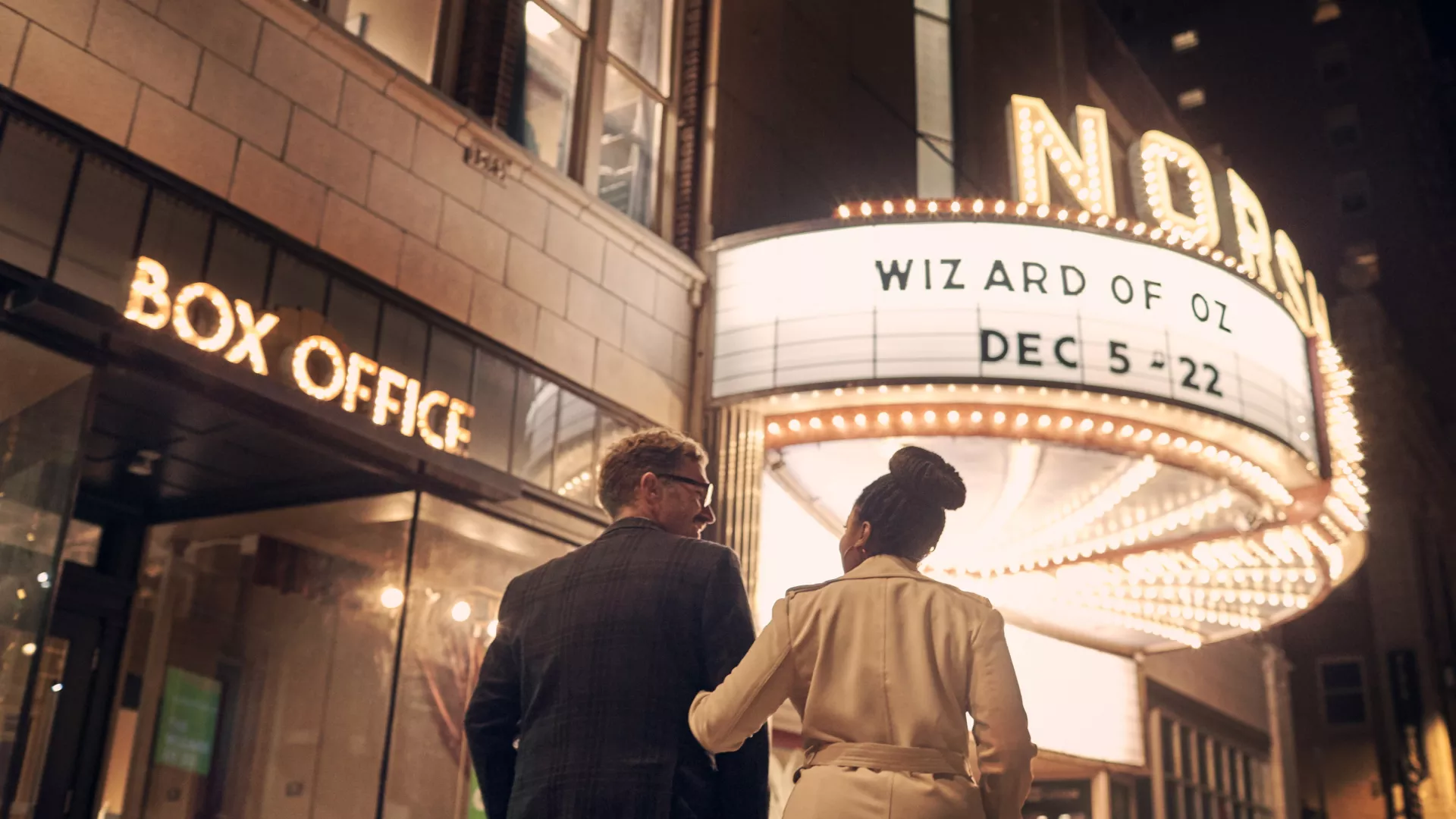 A couple walks up to the marquee outside Norshor Theatre