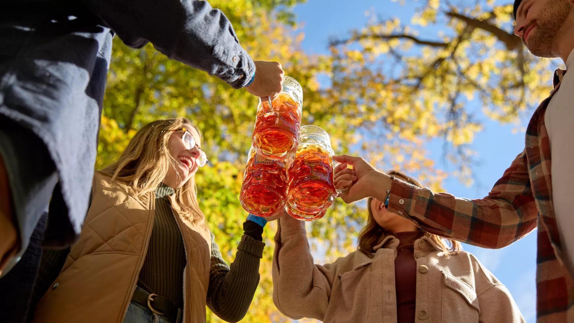 A group of friends toast their steins at Schell's Oktoberfest