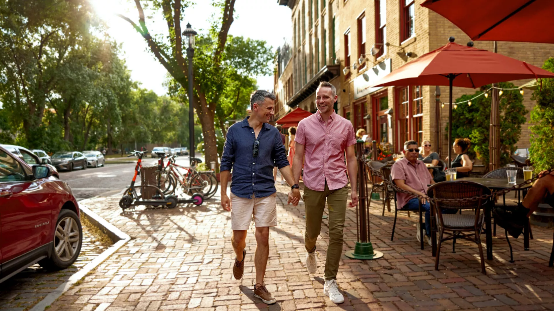 A couple walks past Aster Cafe's patio