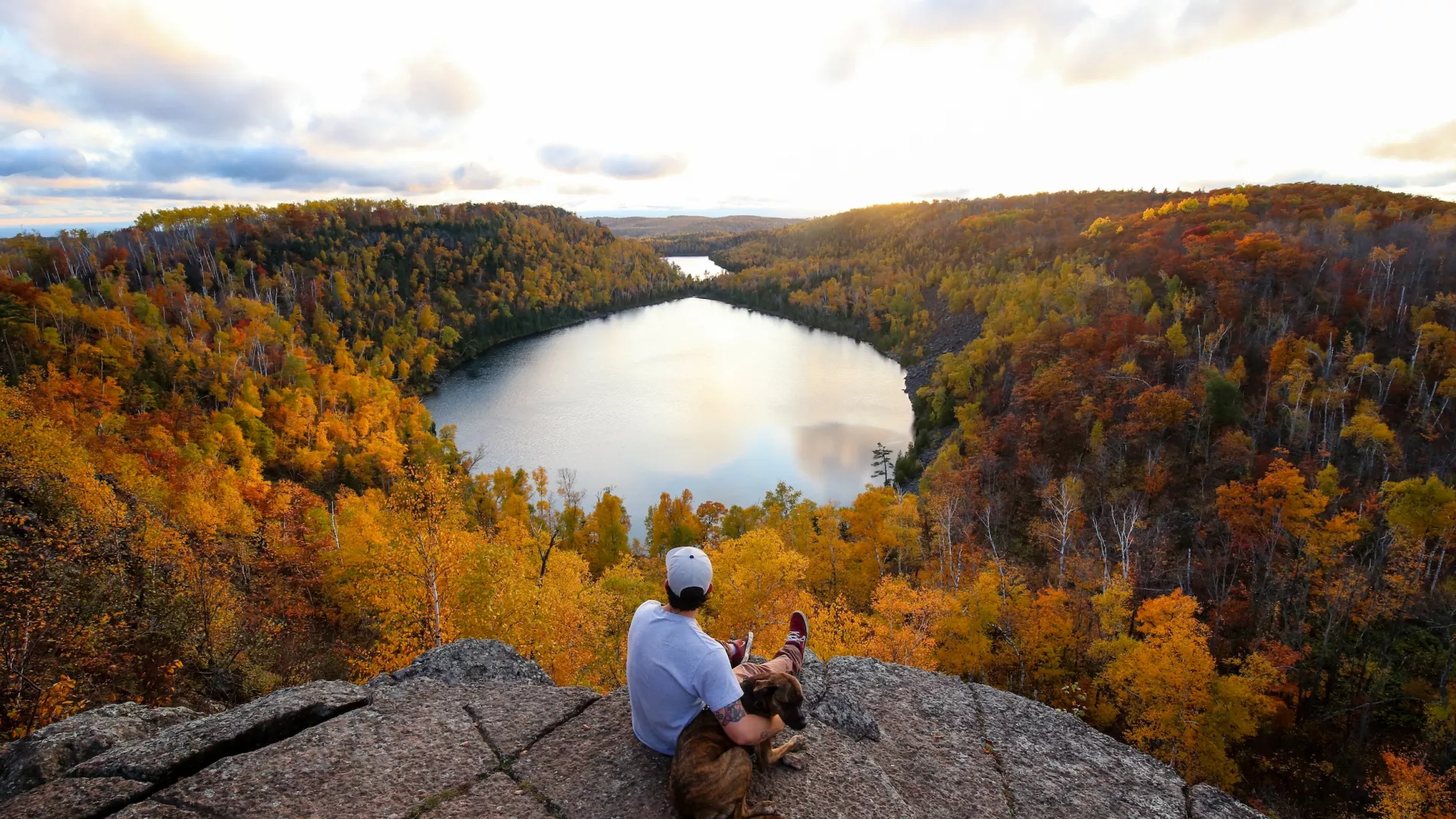 A man with his dog overlooking Bean Bear Lake along the Superior Hiking Trail