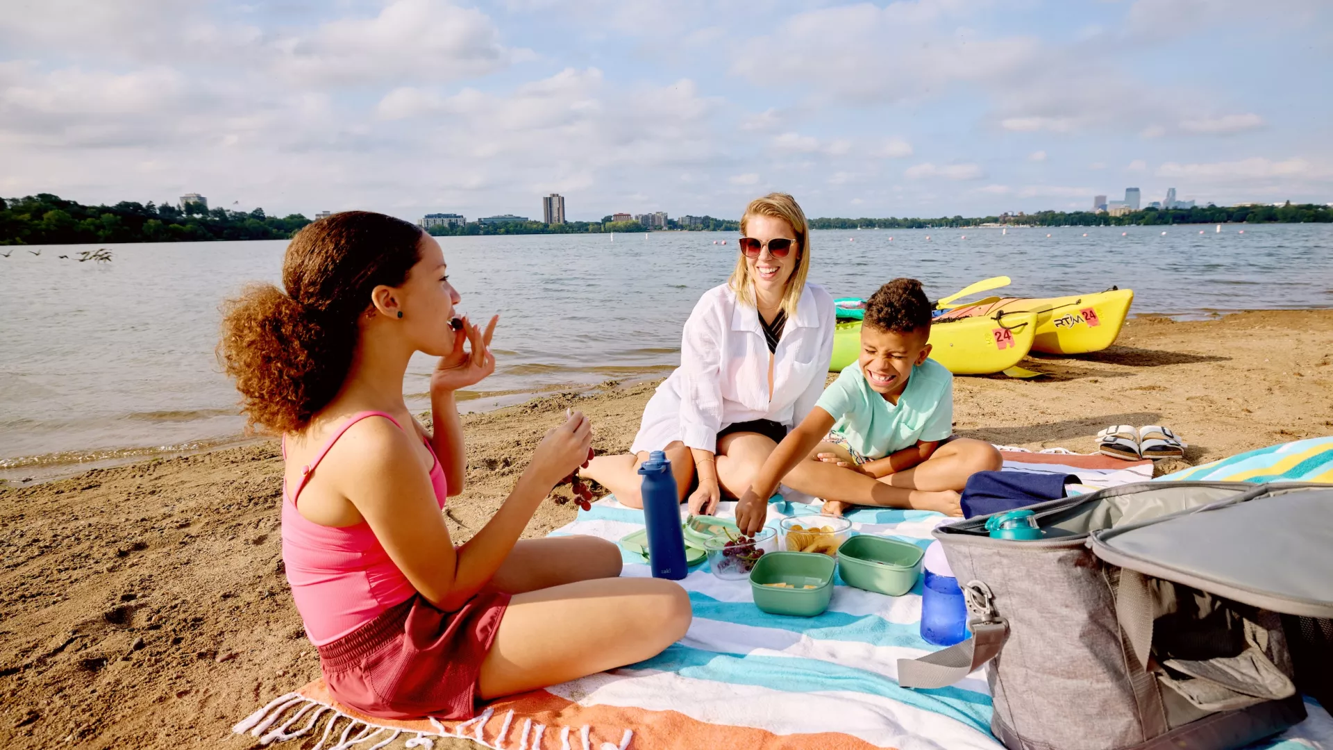 A family having a picnic on the beach at Bde Maka Ska