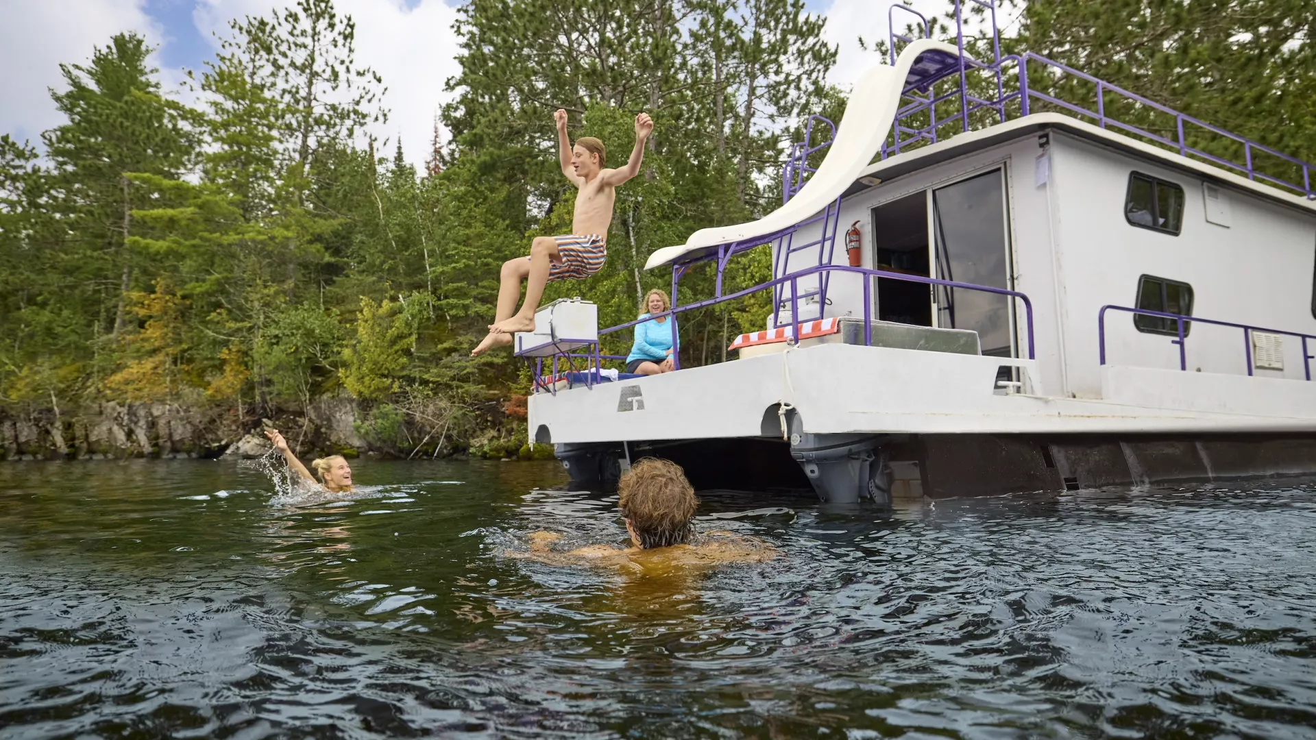 A family swims near their houseboat at Voyageurs National Park