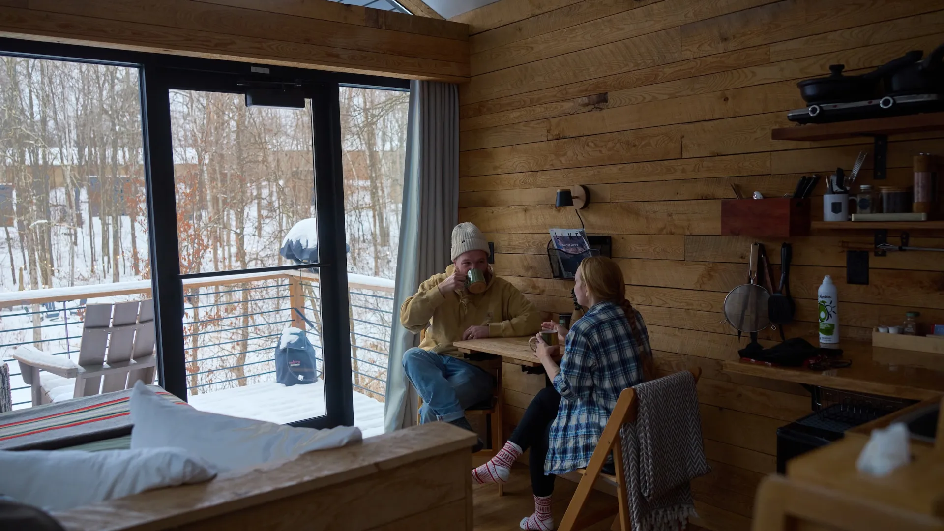 A couple sips coffee in their Cuyuna Cove cabin