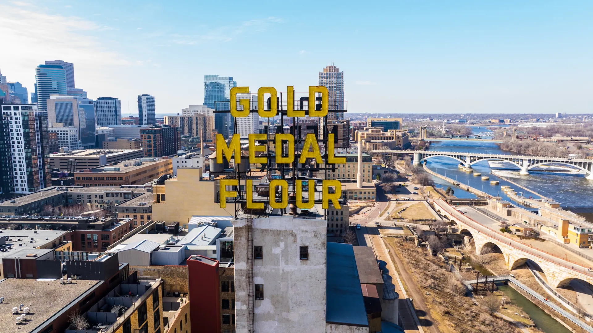 A drone shot of downtown Minneapolis and its iconic Gold Medal Flour sign