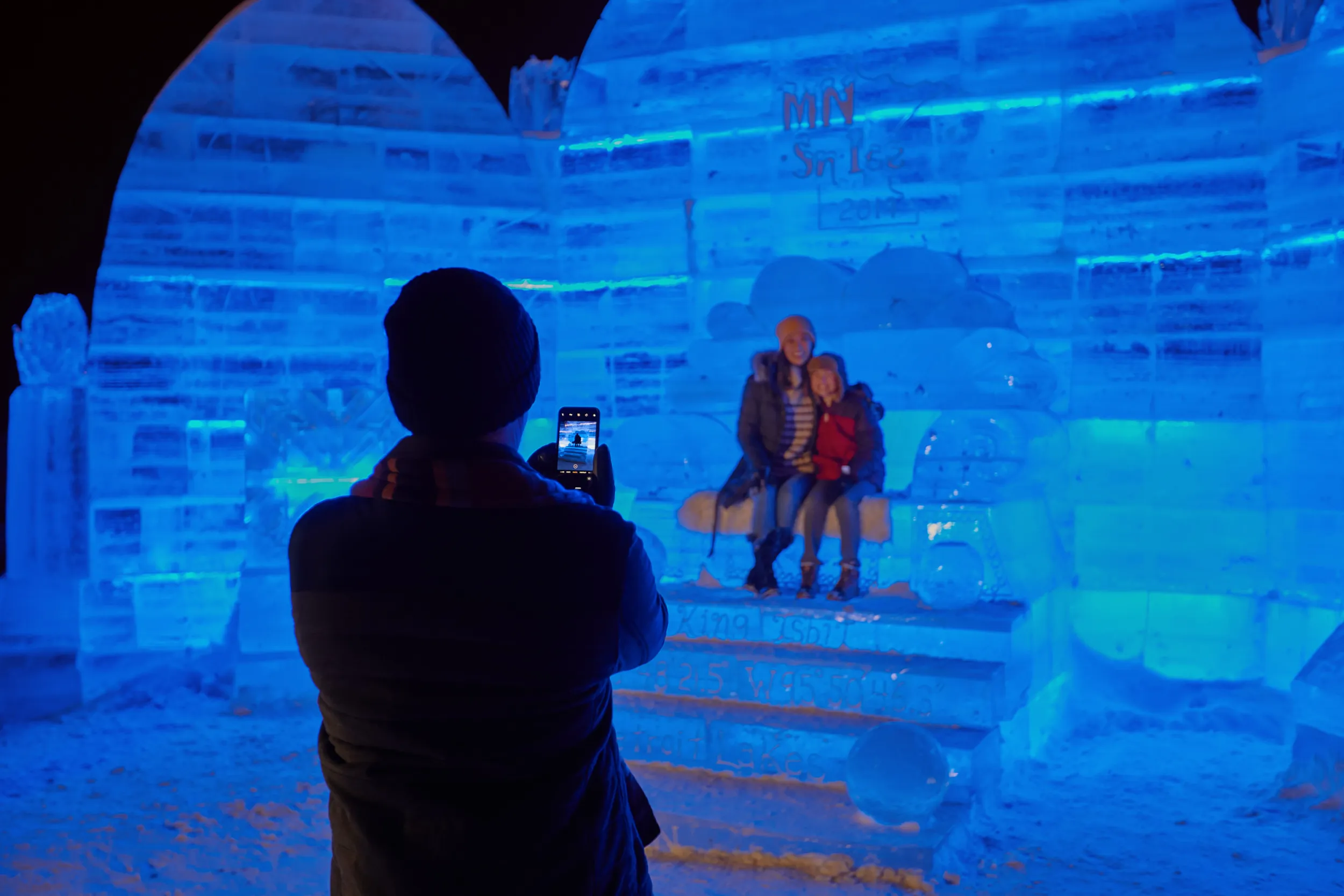 People posing for a picture in the ice palace at Detroit Lakes Polar Fest