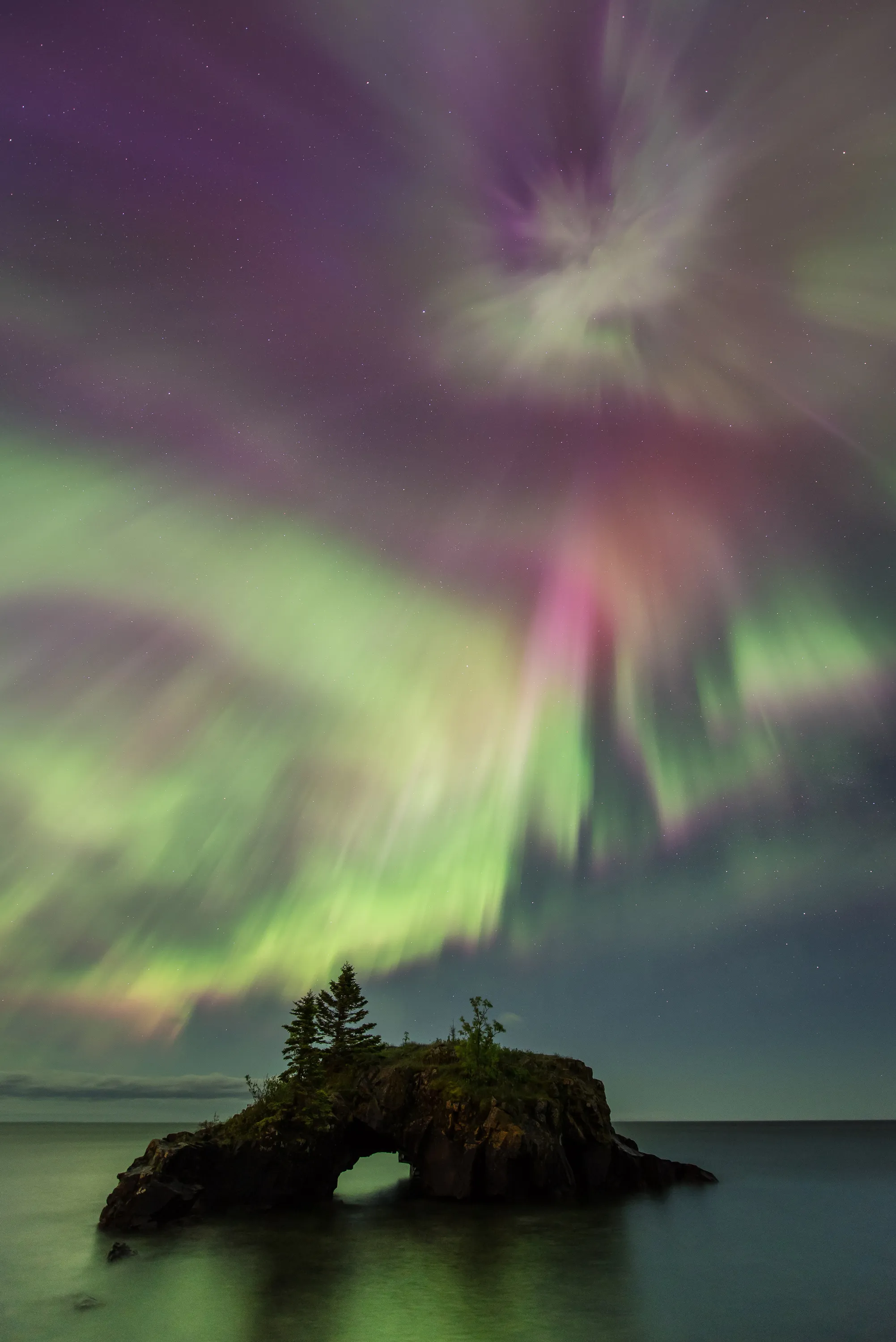 A couple watches the northern lights at Gooseberry Falls State Park
