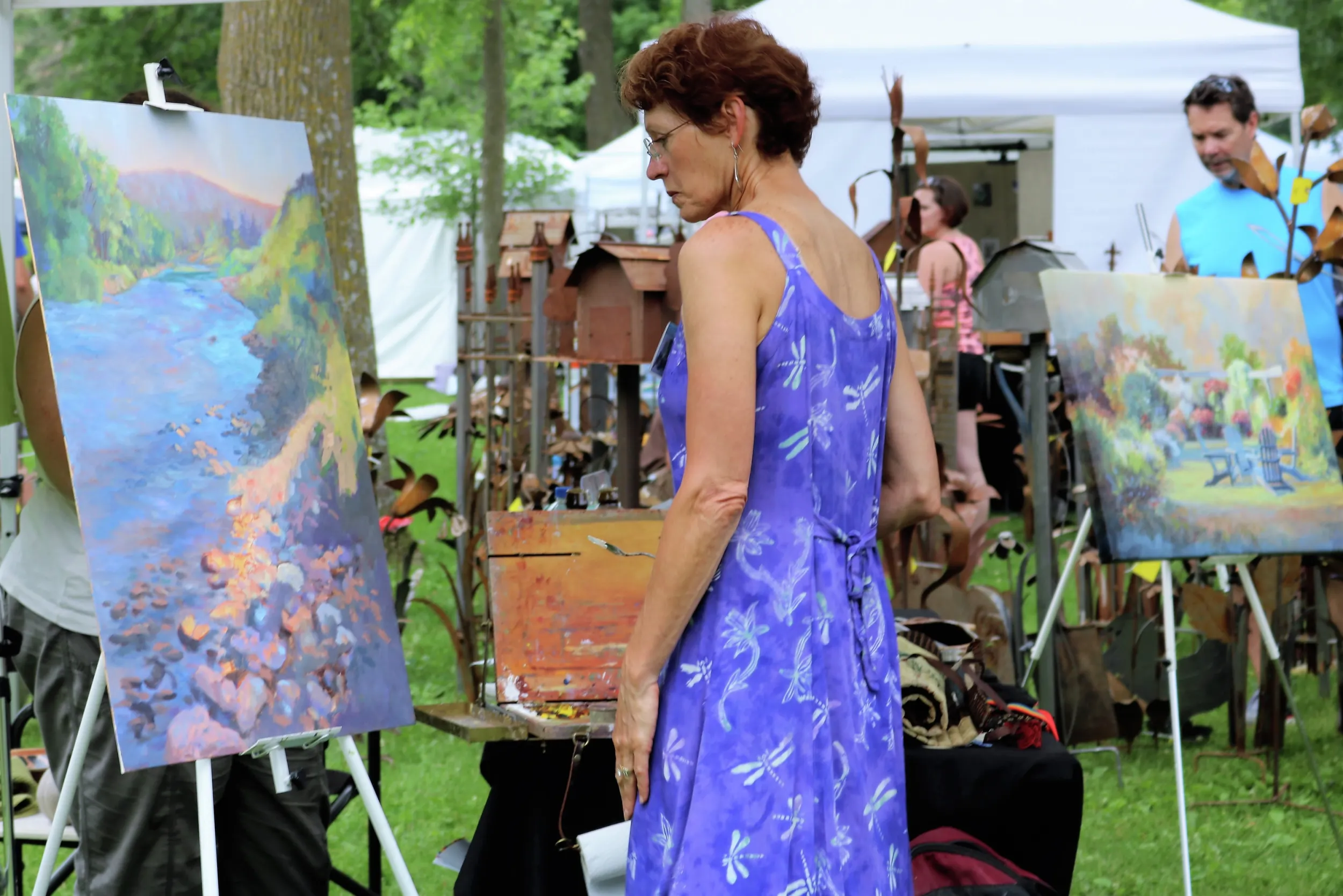 Woman looking at painting at Art in the Park