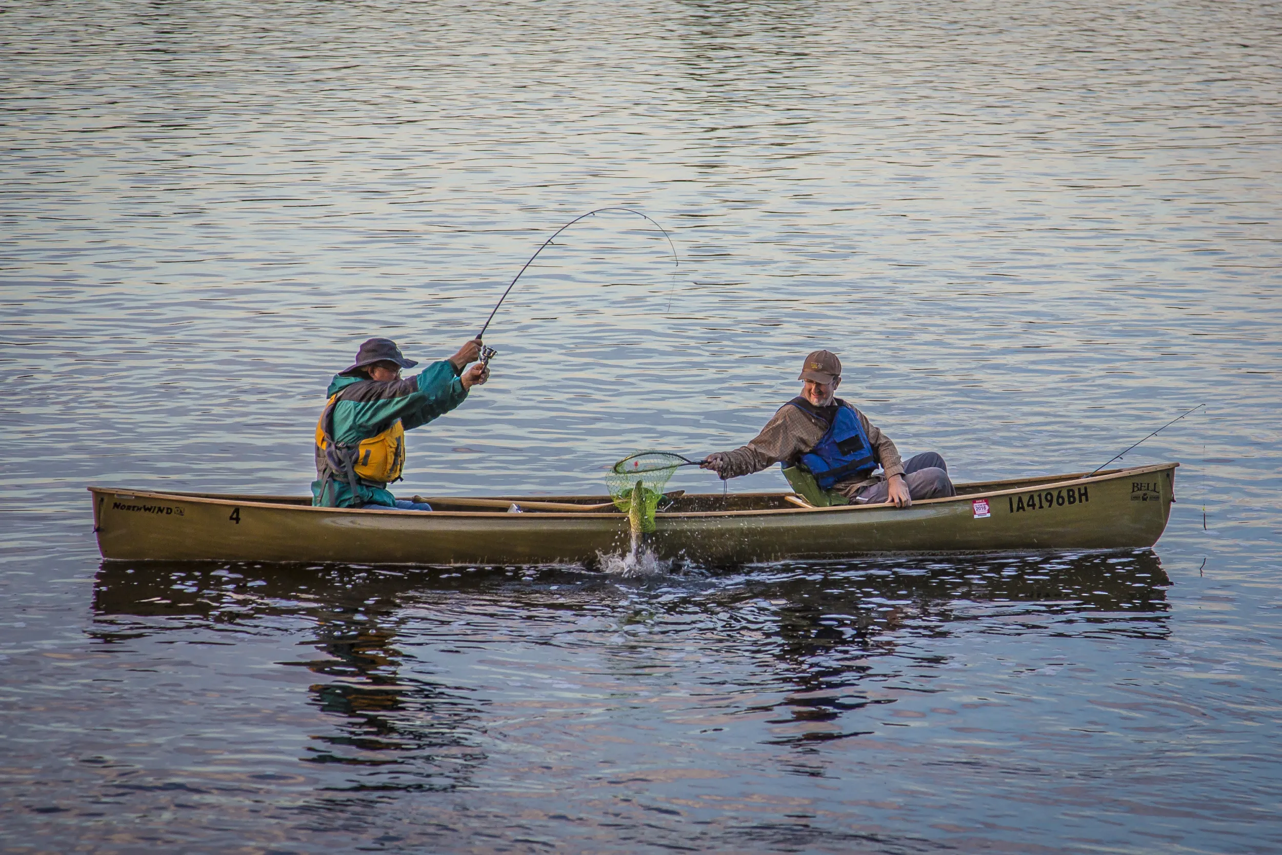 Two men catch a fish in the Boundary Waters