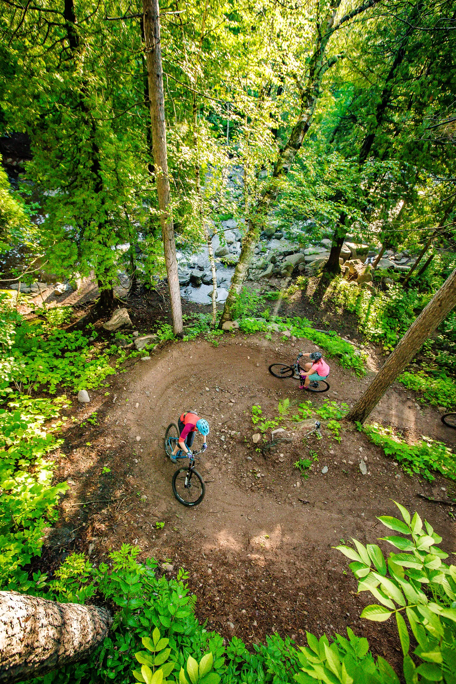 Overhead view of two mountain bikers on a wooded trail in Duluth