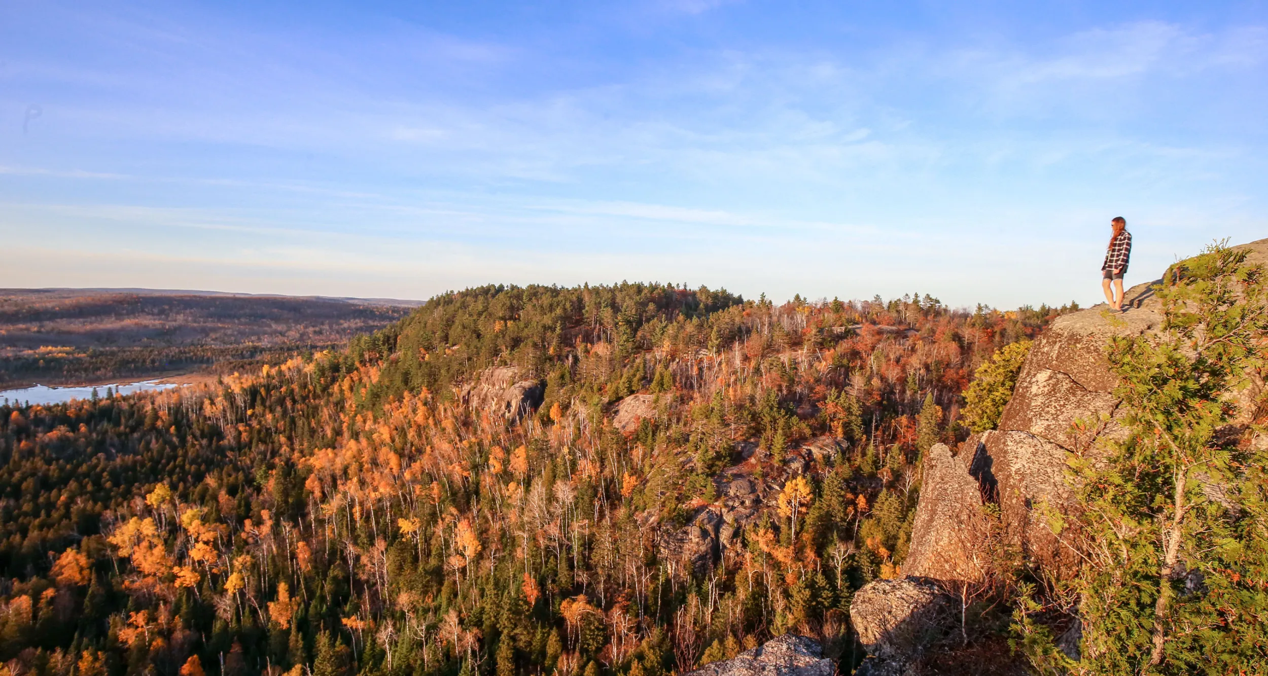 A hiker stands atop section 13 of the Superior Hiking Trail