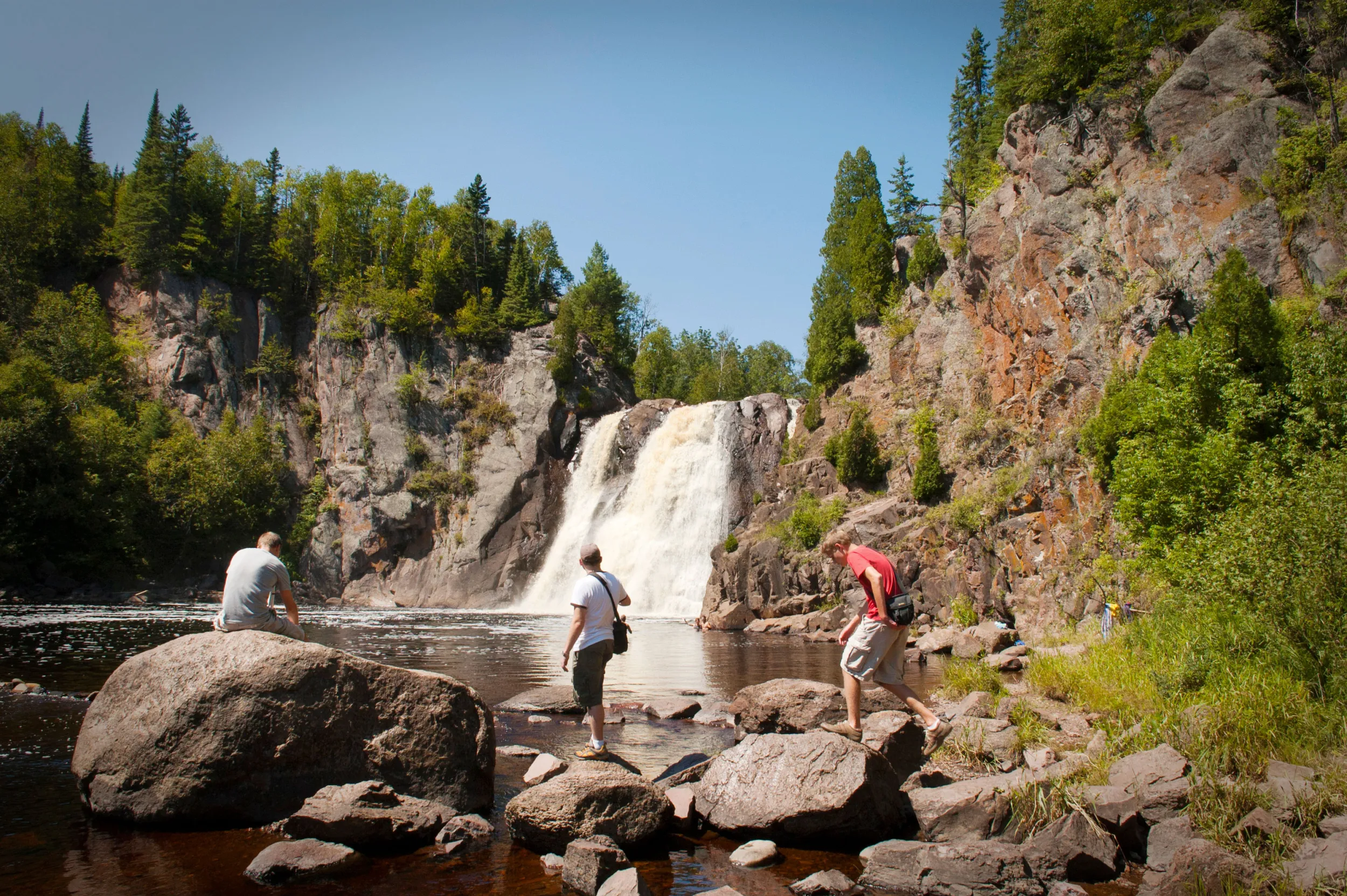 Three men observe the high falls at Tettegouche State Park